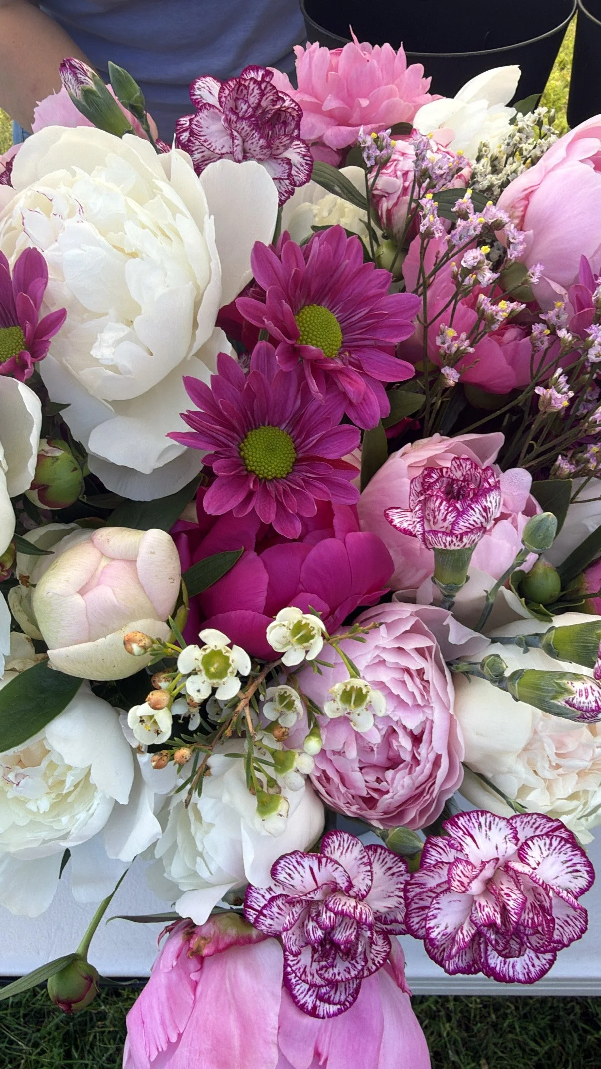 A bouquet of pink, white, and purple flowers, including roses, daisies, and carnations. Howell Farmers market by Hear Here