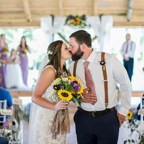 Bride and groom kissing at their wedding reception