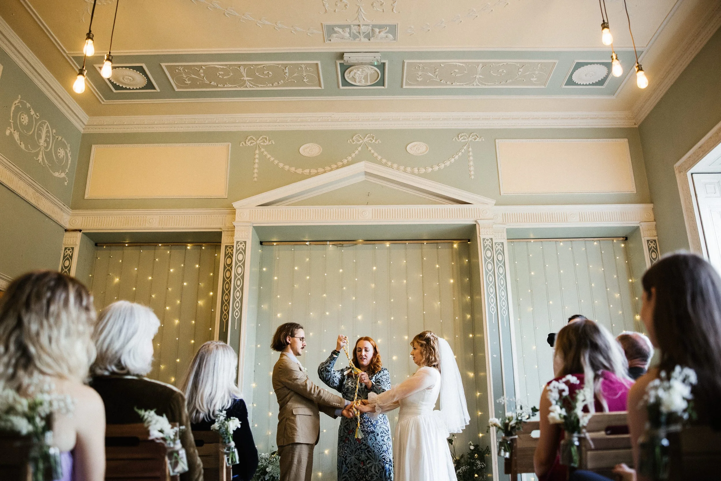 Wedding celebrant doing a wedding handfasting ceremony