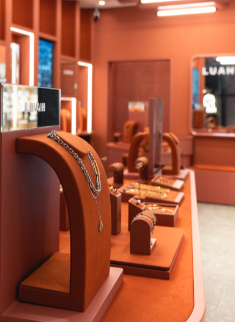 Retail display design for LUAH, Hong Kong, with terracotta necklace stands and tiered jewellery displays.