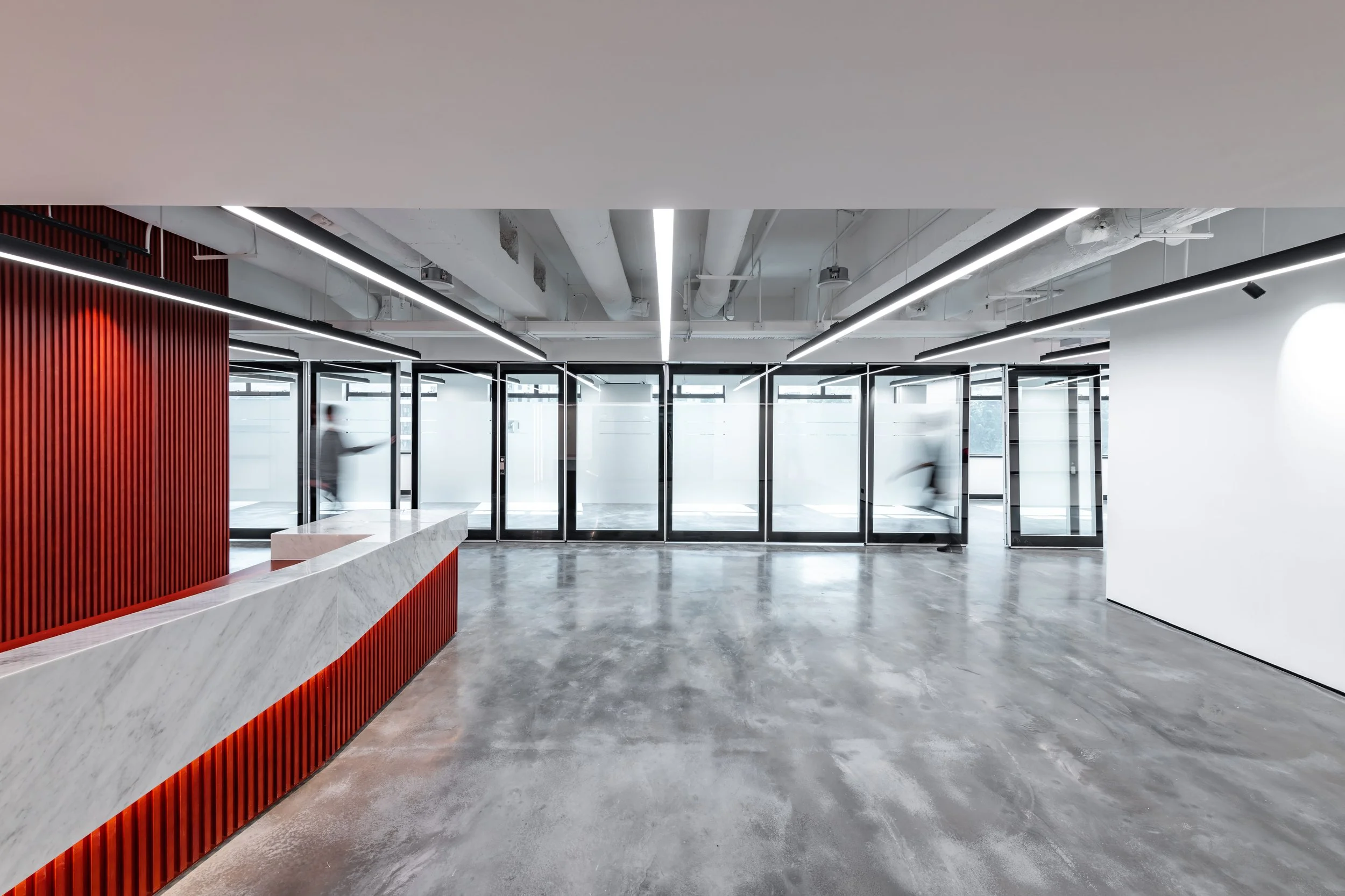 Commercial interior design at Minterellison LLP Wan Chai, Hong Kong featuring entrance shot of reception area with distinct polished concrete flooring.