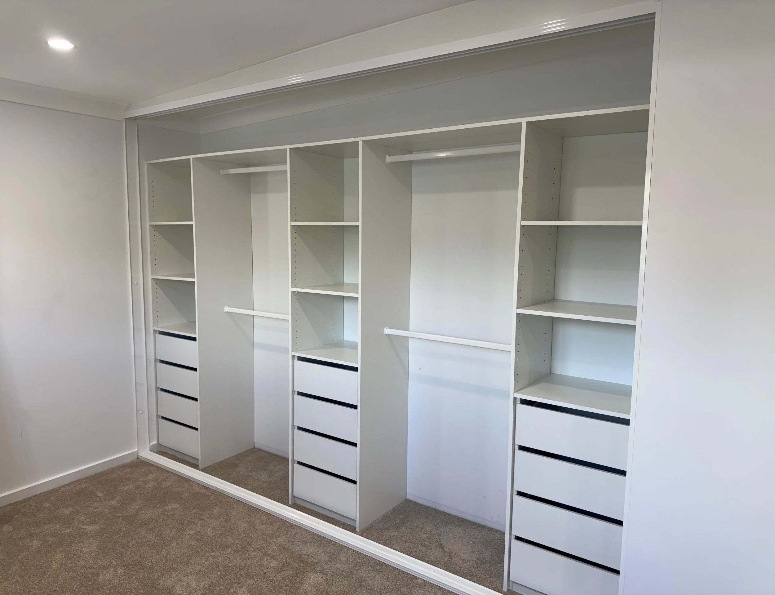 Built-in wardrobe internals installed with drawers, shelves and hanging space
