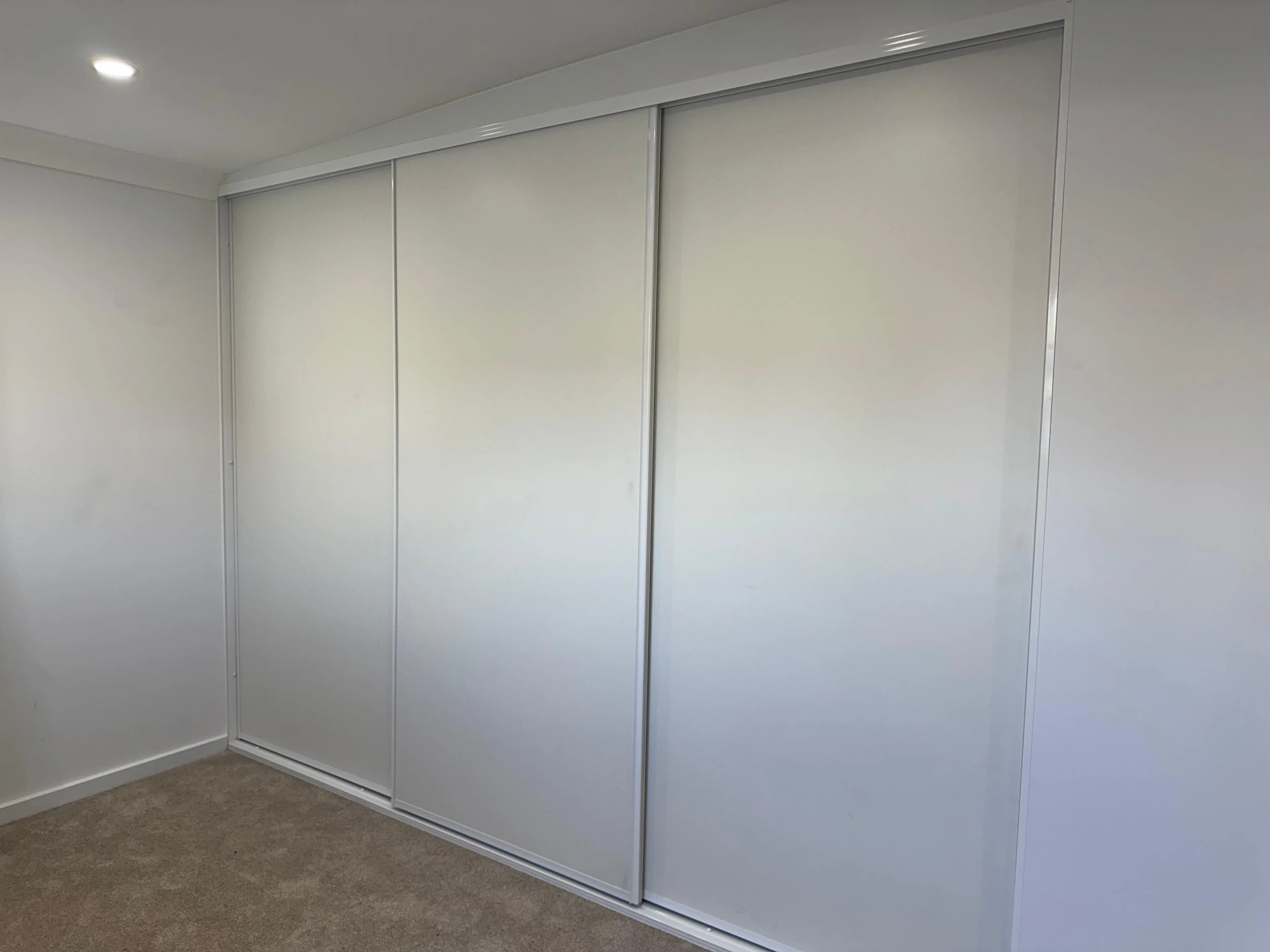 Completed built-in sliding wardrobe with finished doors