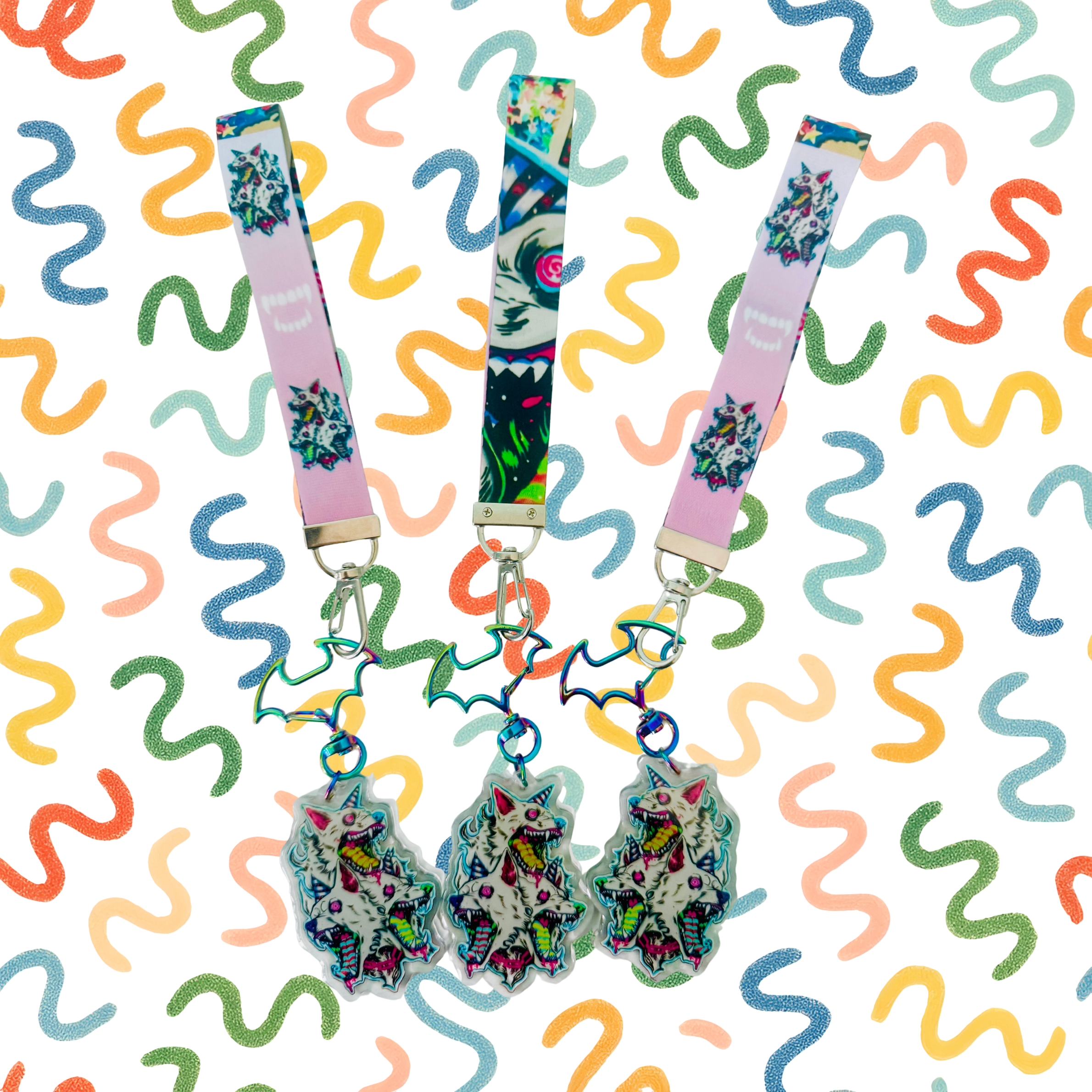 Colorful lanyards with tiger and abstract patterns hanging against a background of multicolored glittery squiggly lines.