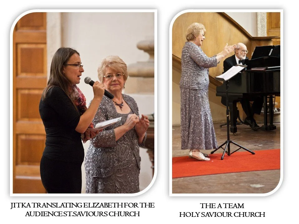 Two women speaking and singing during a church service at Holy Saviour Church, with a man playing the piano in the background.