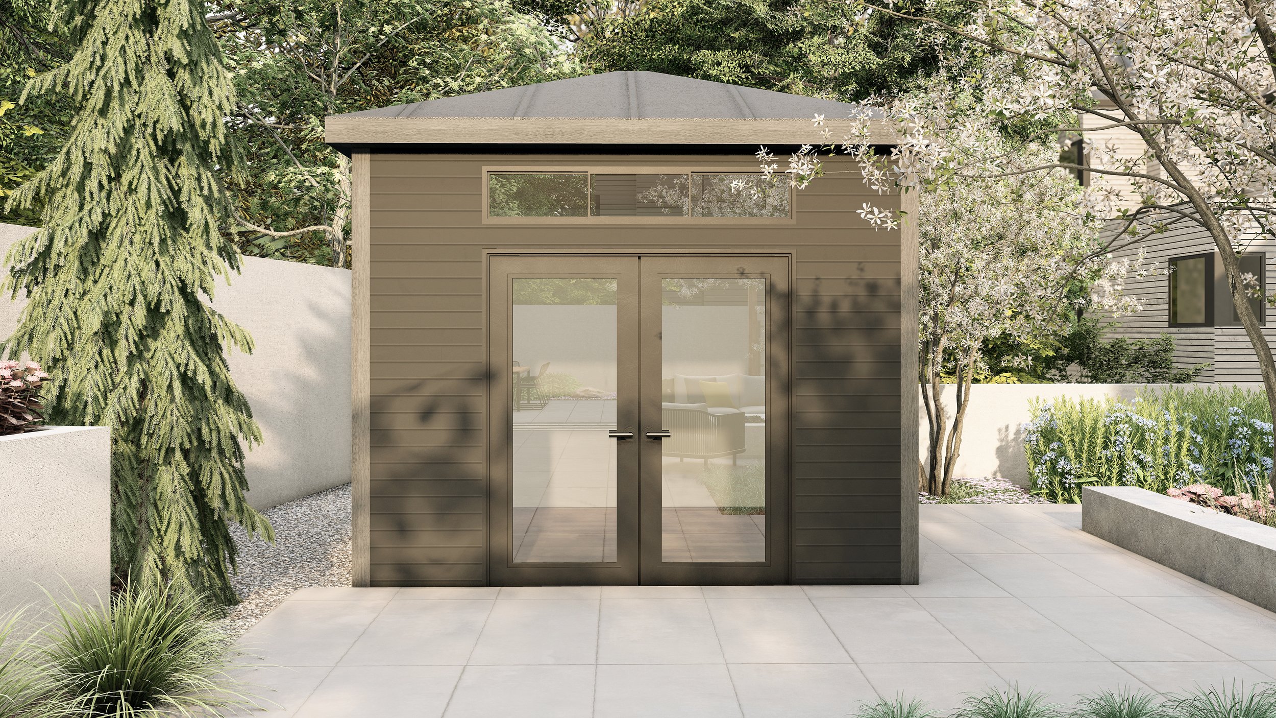 A modern, small brown shed with a glass double door, surrounded by landscaped greenery and patio in a residential garden.
