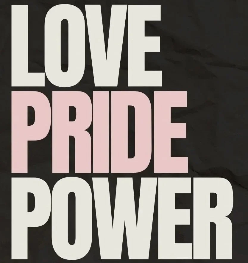 Text reading 'Love Pride Power' with 'Love' and 'Power' in white, and 'Pride' in pink, on a black background.