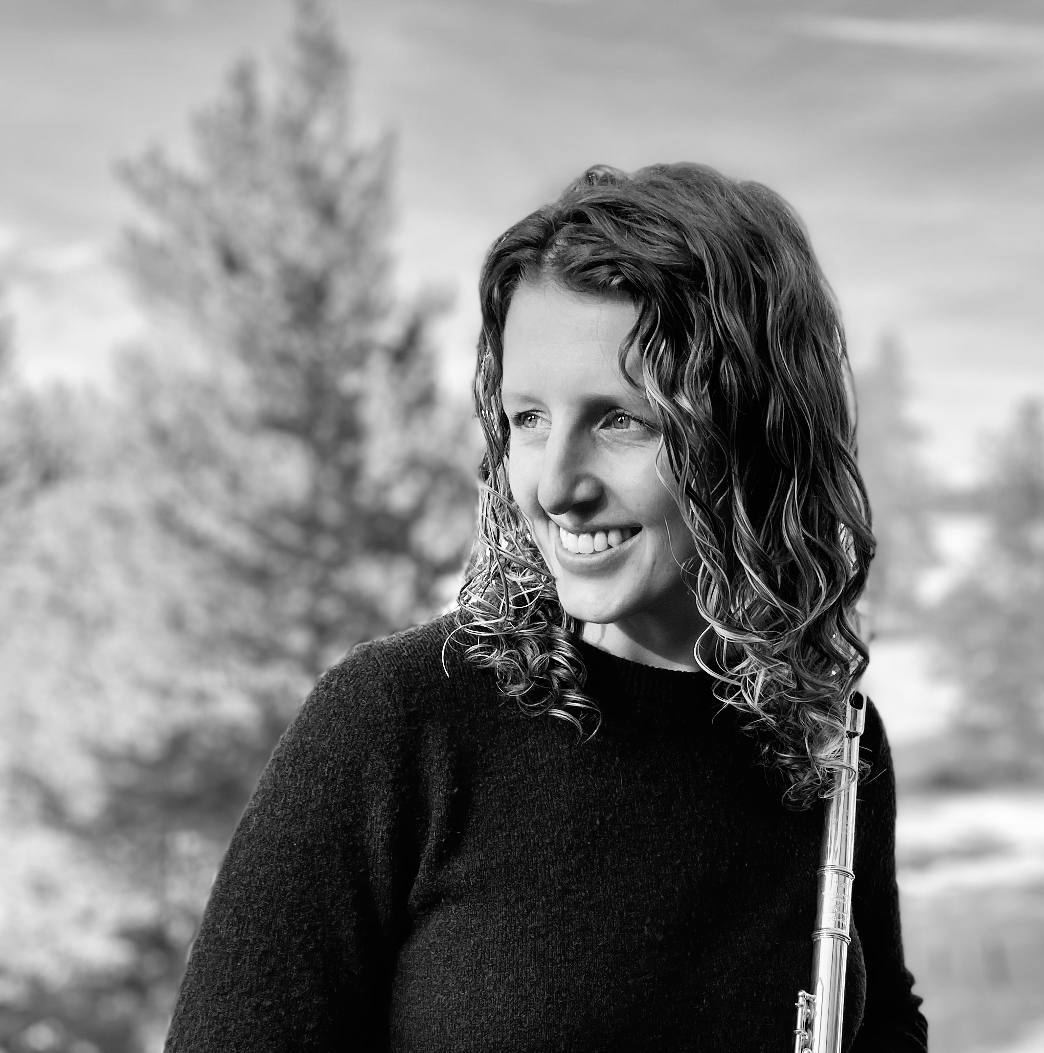 Kelsie Kitz, a music educator from Idaho, a black and white photo of a woman with curly hair smiling