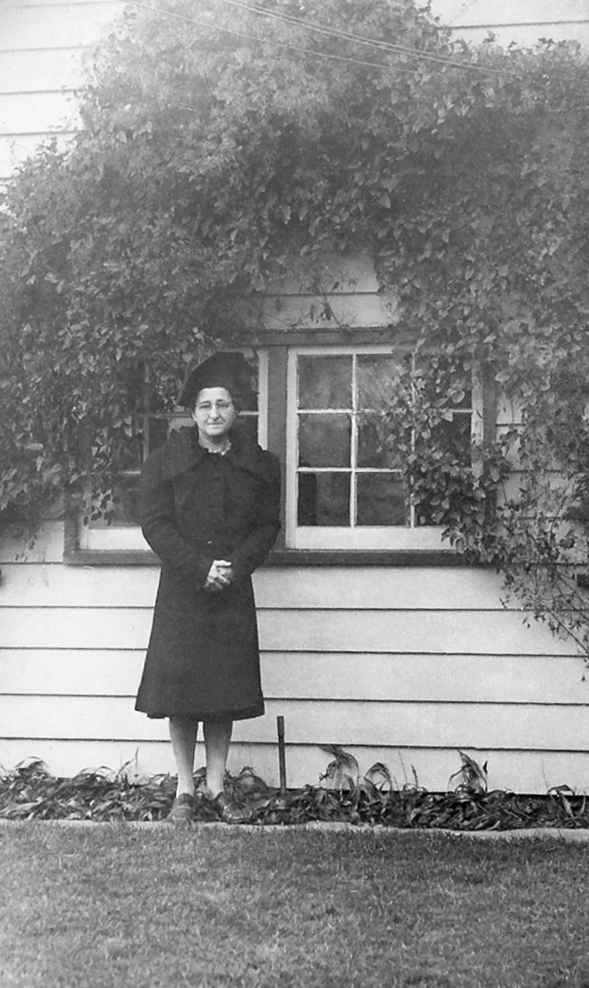 Florence (Cusettes) Rittinger standing in the back yard of the Philadelphia house. 