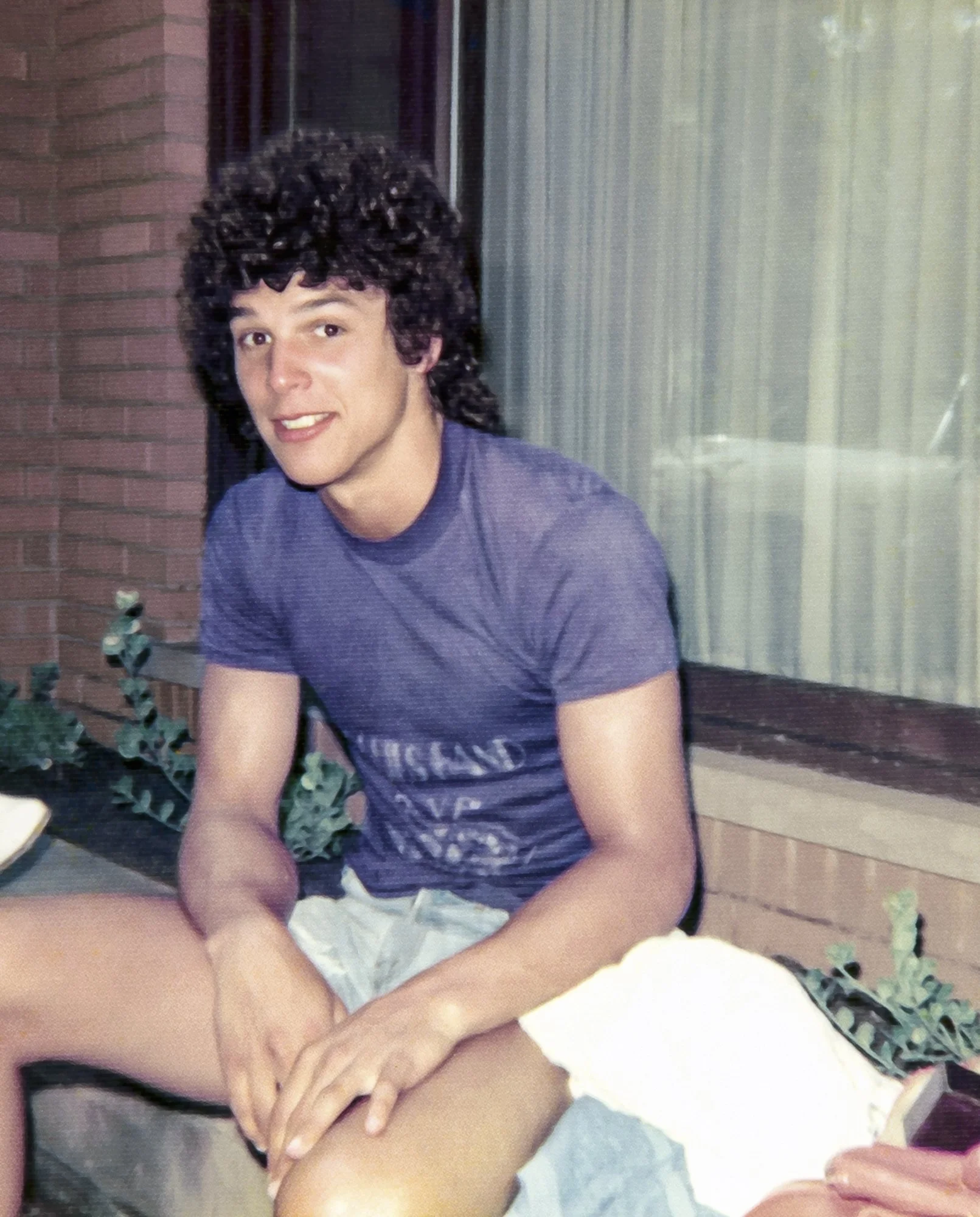Rob sitting outside the Schramke house. (1977)