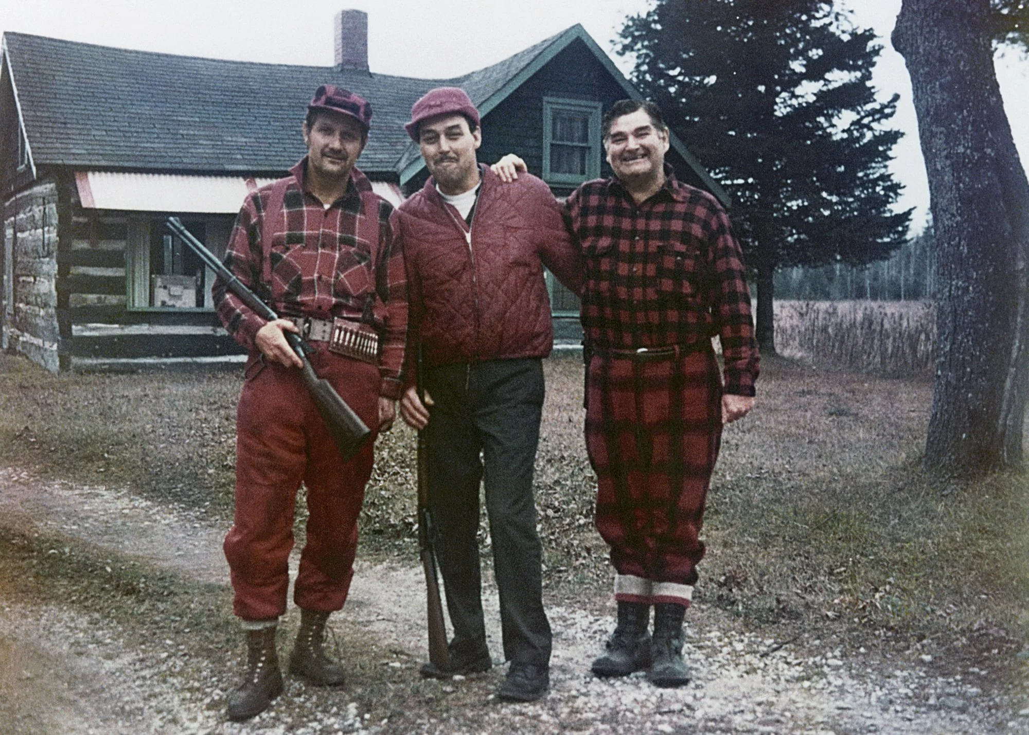 Frank Cynowa, Bob Travis, and Bob Morton. The photo was taken outside a cabin that they would rent for deer hunting season. 