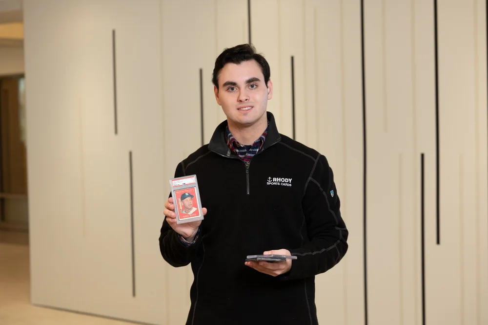 Chris Lambros holding a graded card
