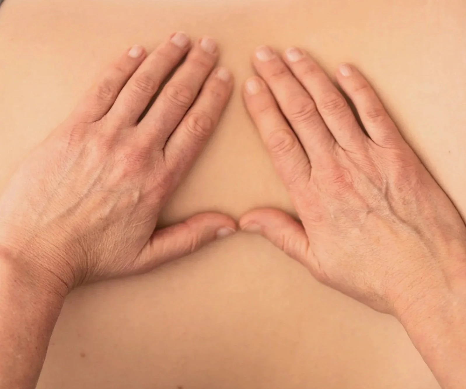 Two hands providing Myofascial Release. John F. Barnes