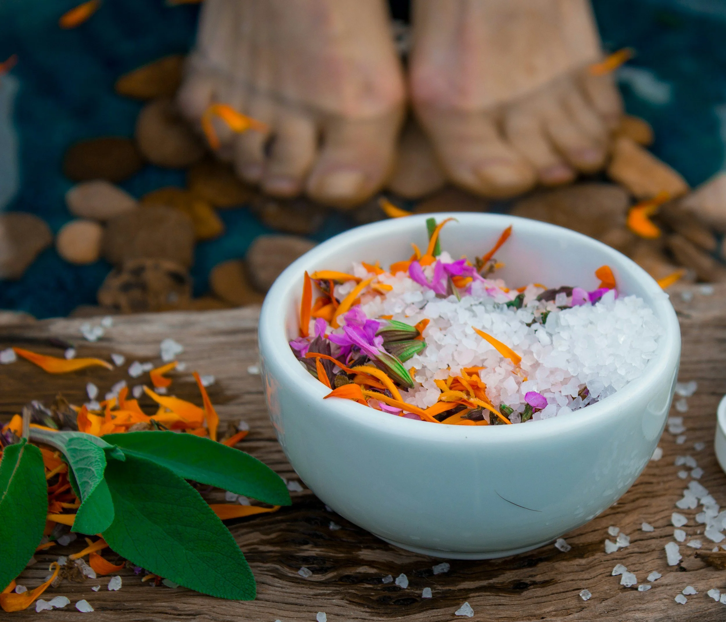 toes in front of an herb and salt bowl prepare for foot bath