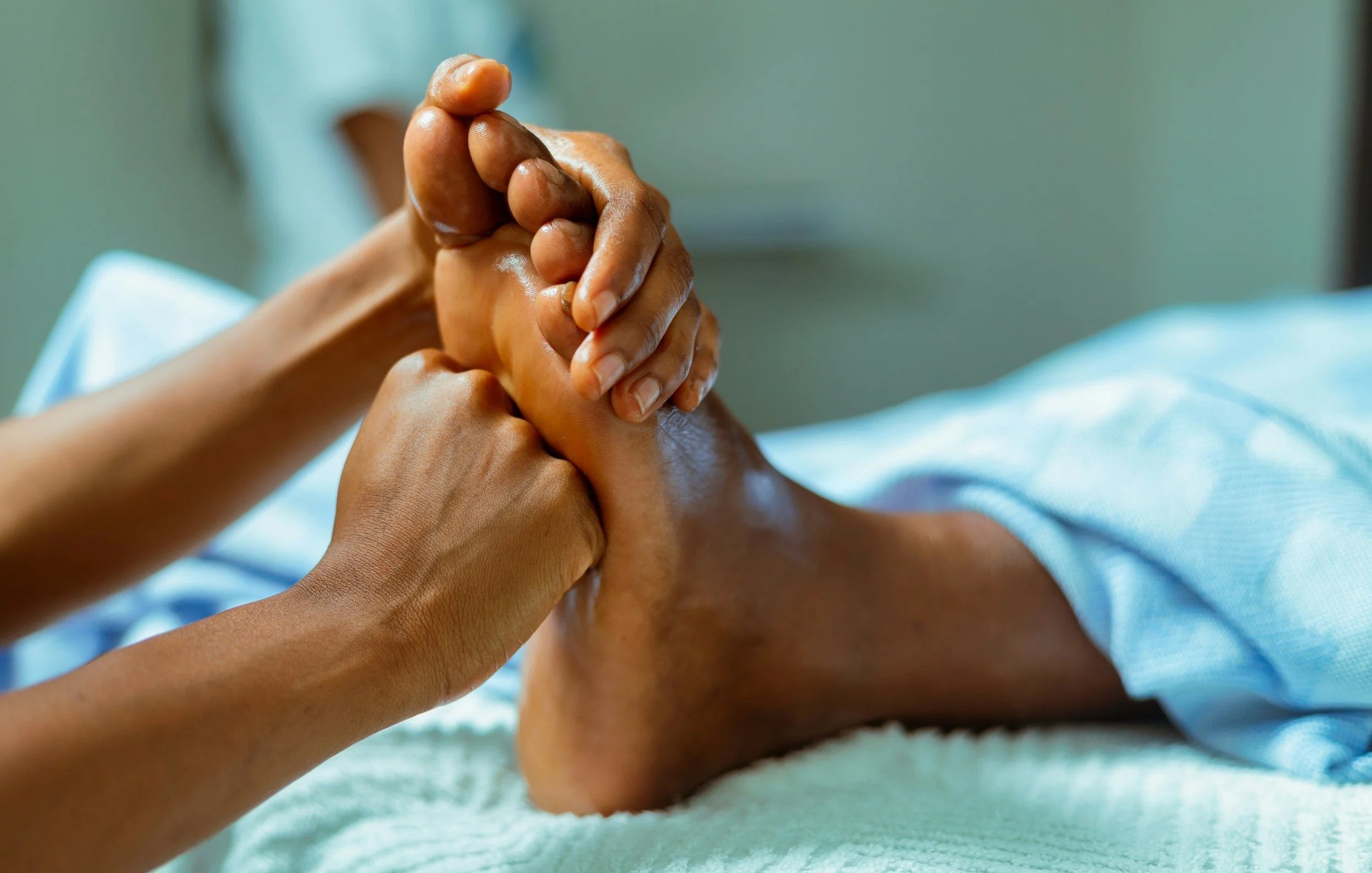 A person performing a foot massage or reflexology