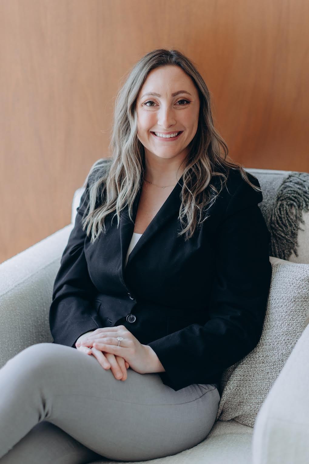 Alexa Sengstock, LSW, therapist at Clove Counseling in Lisle, IL, sitting in a cozy therapy chair and offering trauma-informed therapy to teens for anxiety, depression, and life transitions.