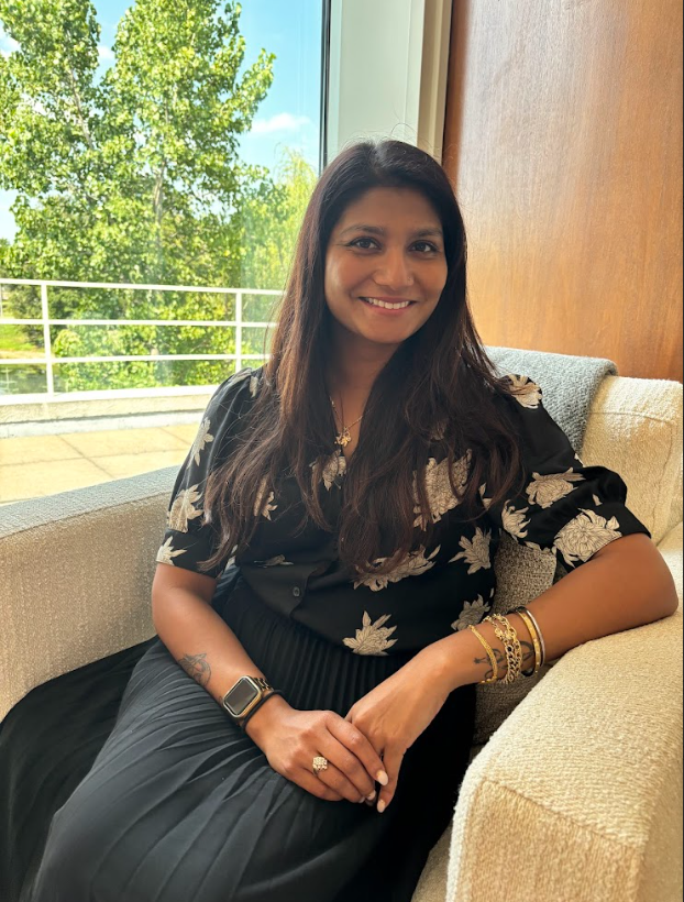 Simmi Gandhi, QMHP, trauma-focused therapist at Clove Counseling in Lisle, IL, seated by a bright window and providing EMDR and trauma-informed therapy for PTSD, OCD, and other diagnosed disorders.