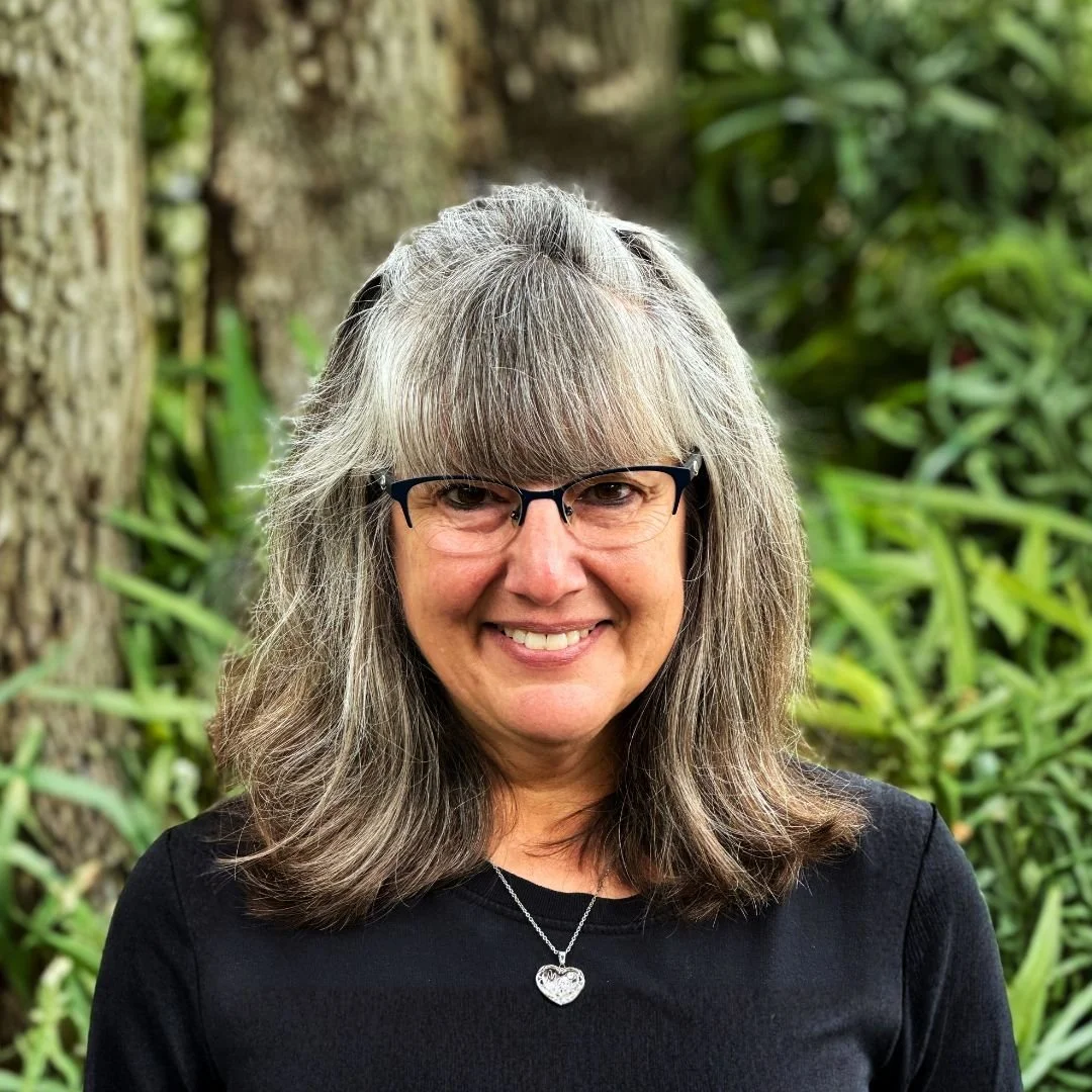 Women with sliver locket and gray hair who is the JupiterFIRST Church Preschool Co-Director, Jennifer Dunn