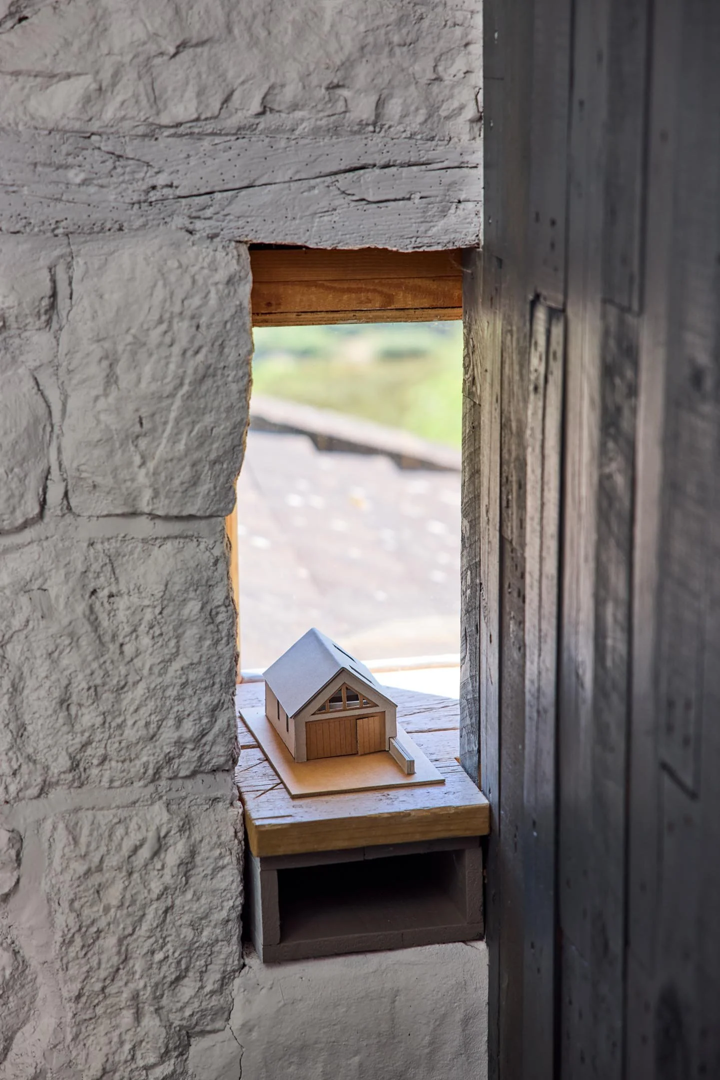 A hand-made architectural model of a building within a design studio