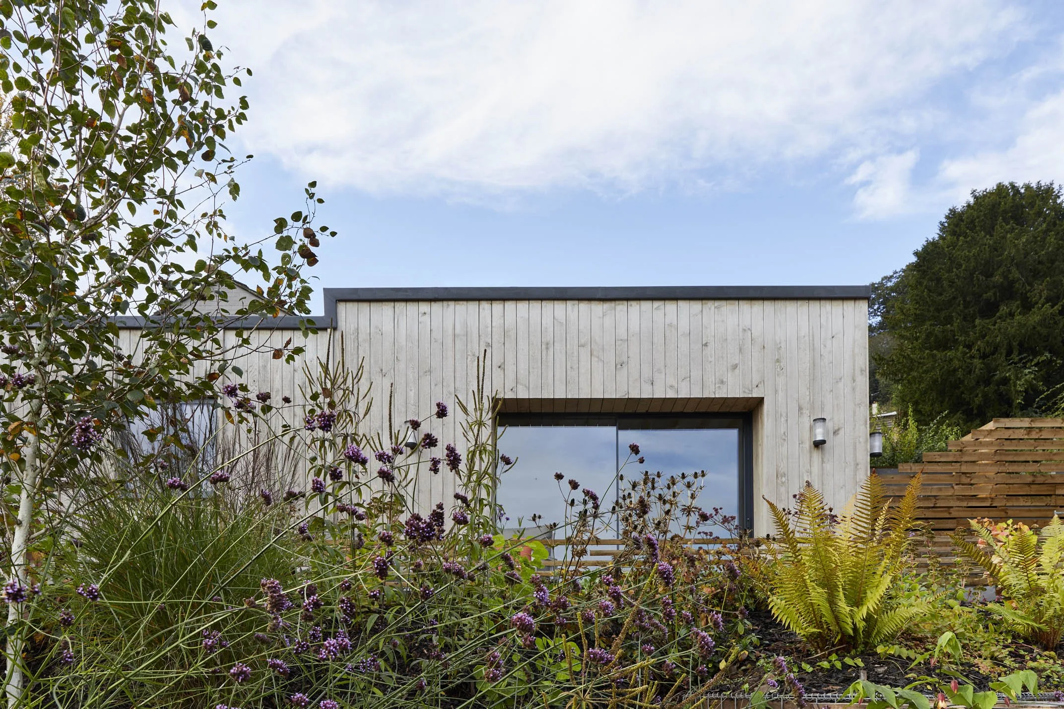 Architectural photograph of the retreat resting lightly within the sloping landscape.