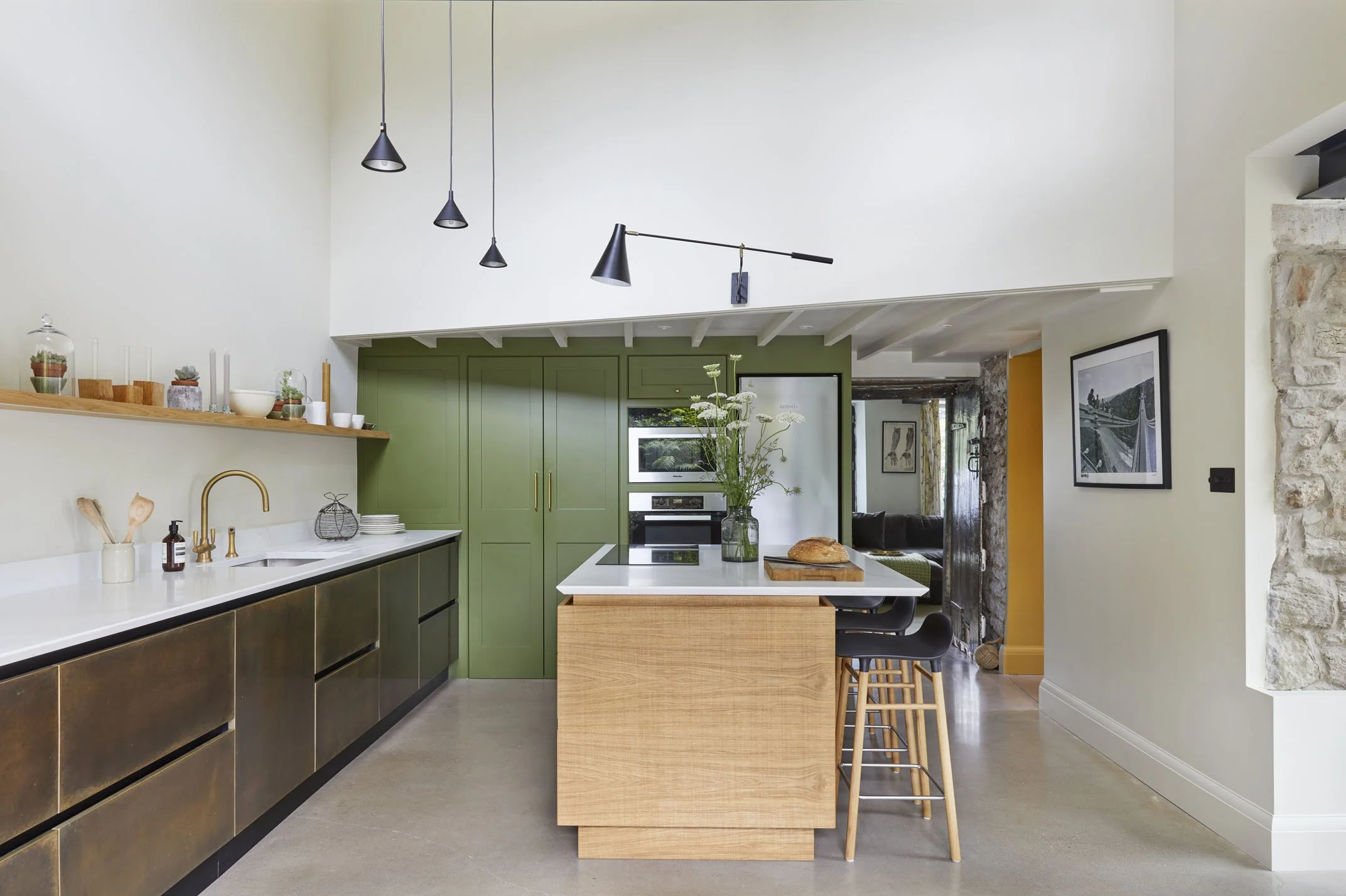 Open-plan kitchen interior with natural light and mezzanine above