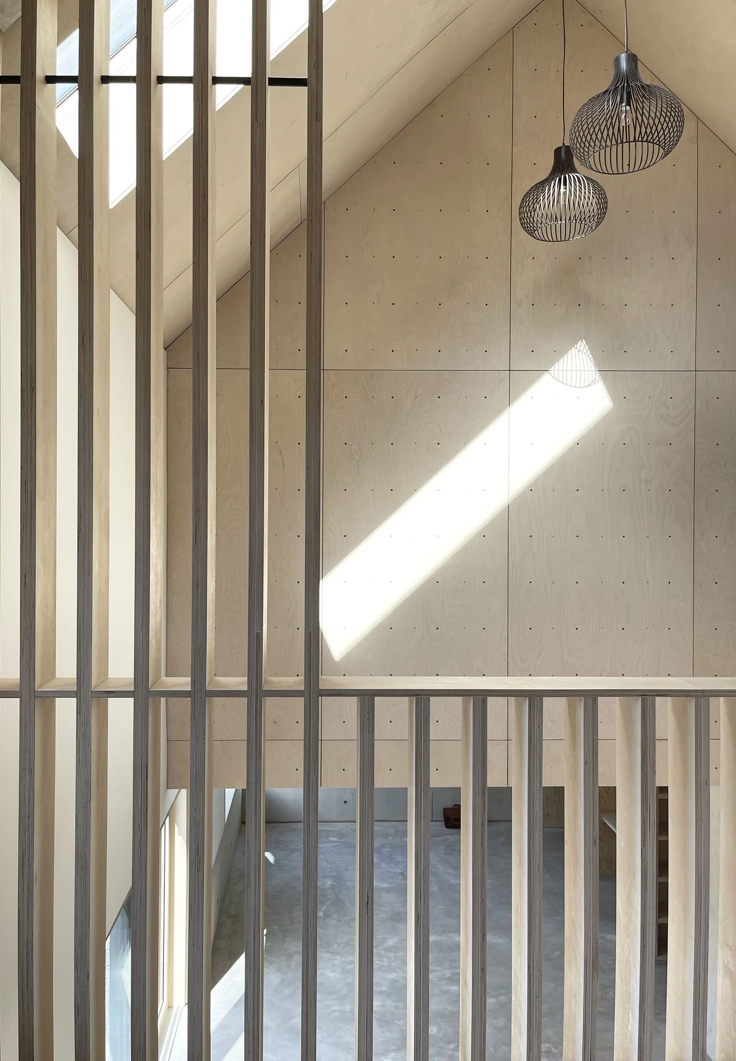 Interior showing softly defined living areas that flow together, balancing openness with moments of spatial separation.