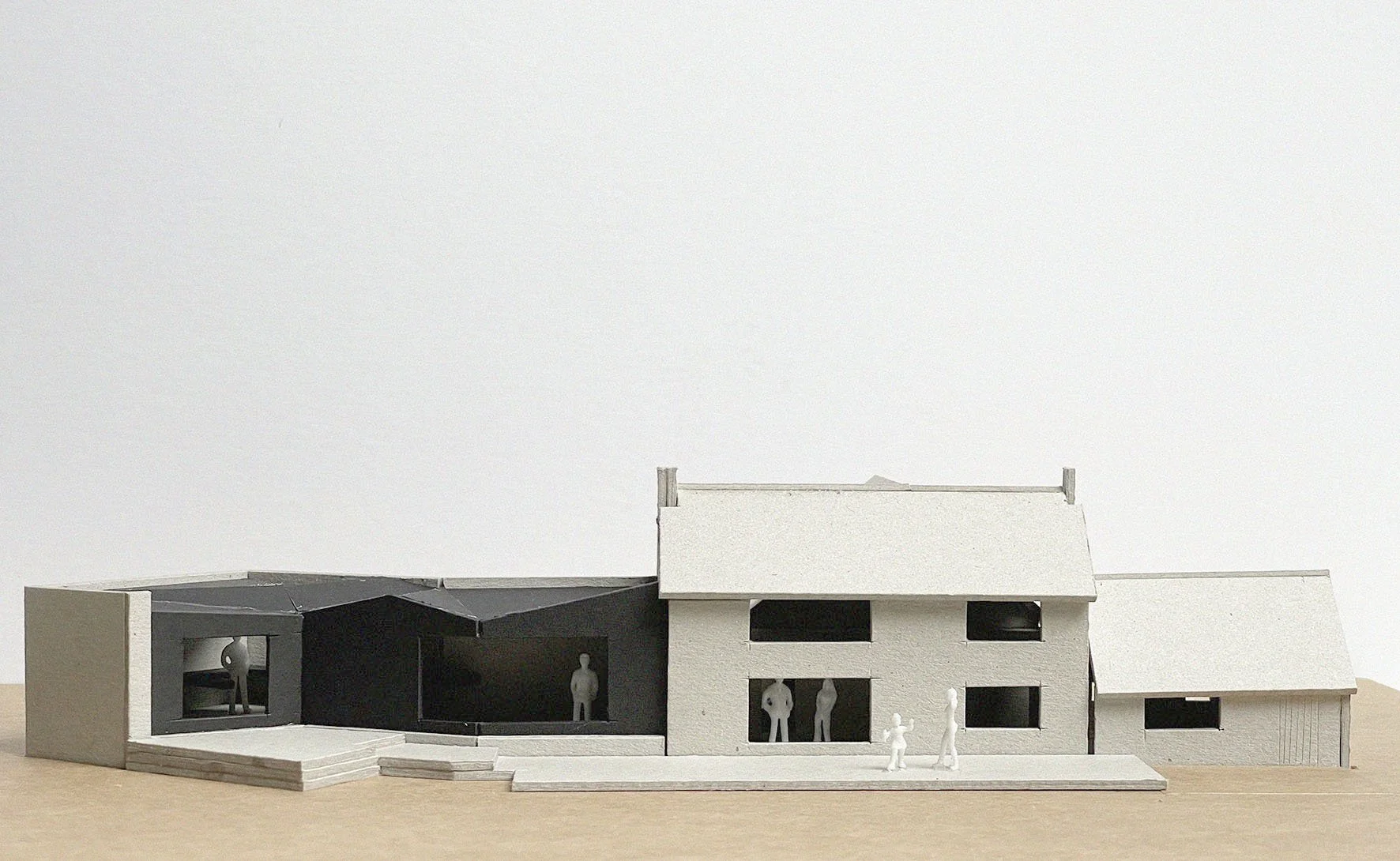 Hand-built architectural model exploring the massing, rooflines, and material relationships of the cottage and extension.