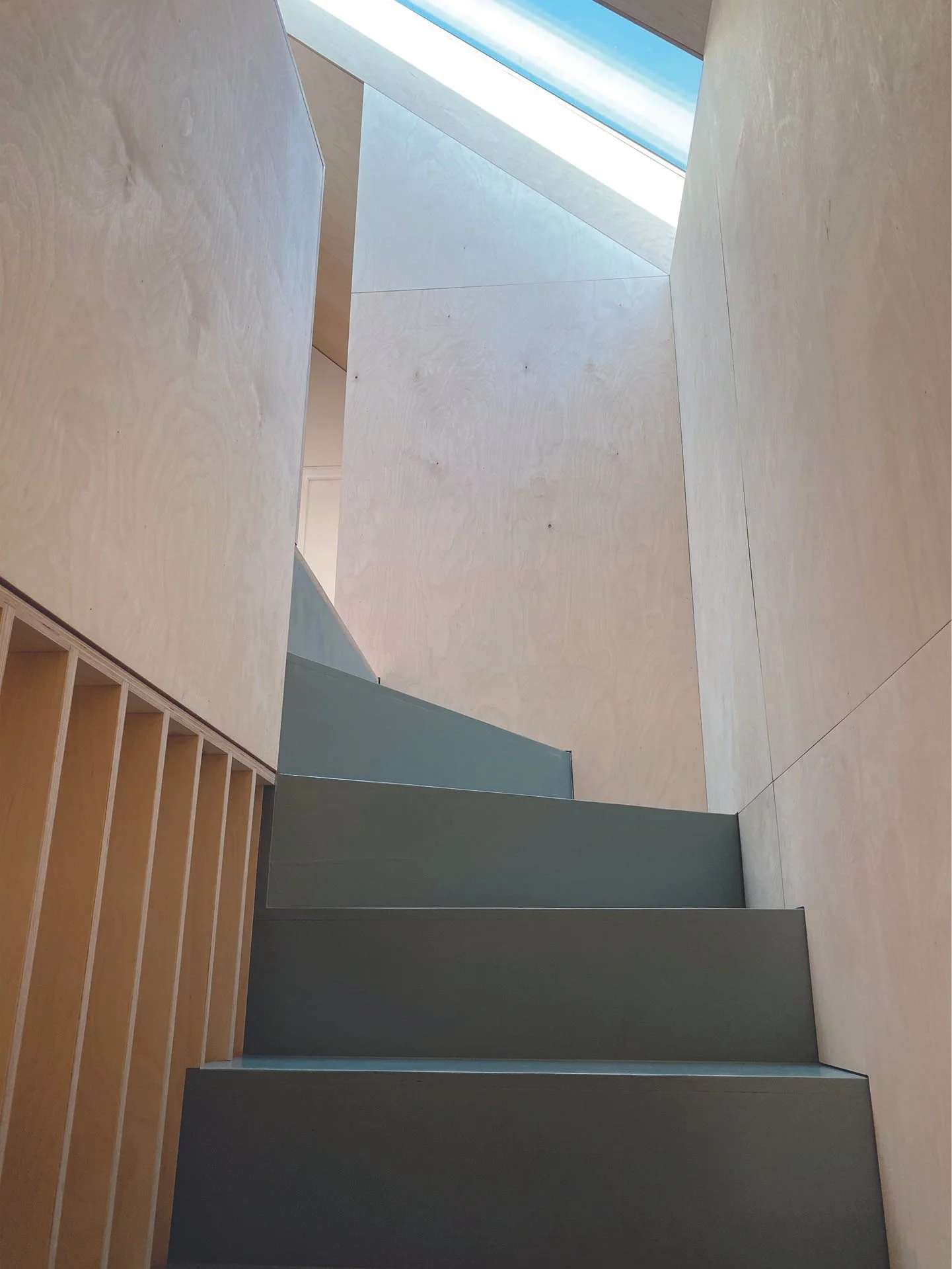 Architectural staircase detail combining minimalist design with warm timber textures and natural light.