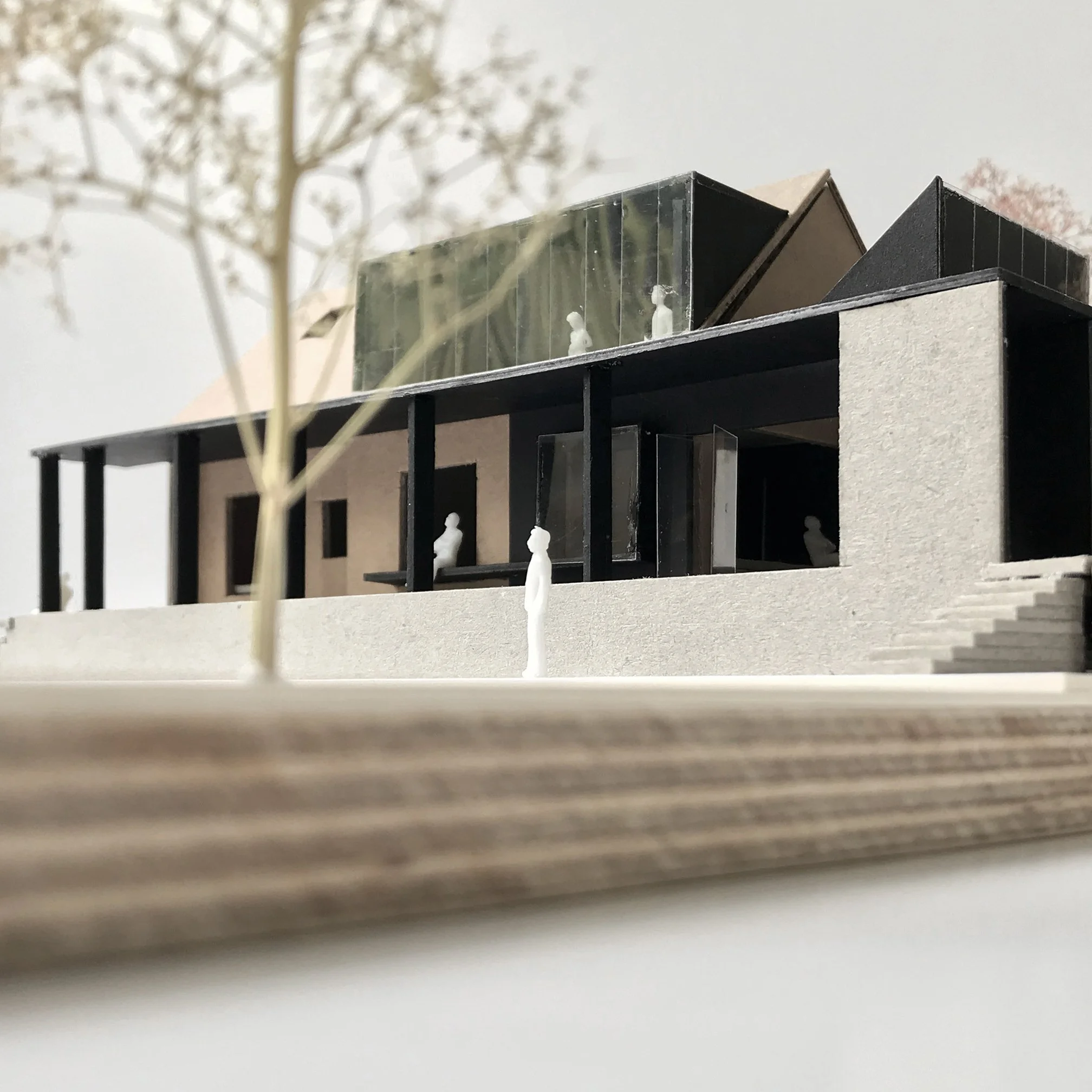 Physical architecture model illustrating how the extension stitches into the existing bungalow form and redefines its relationship to the landscape.