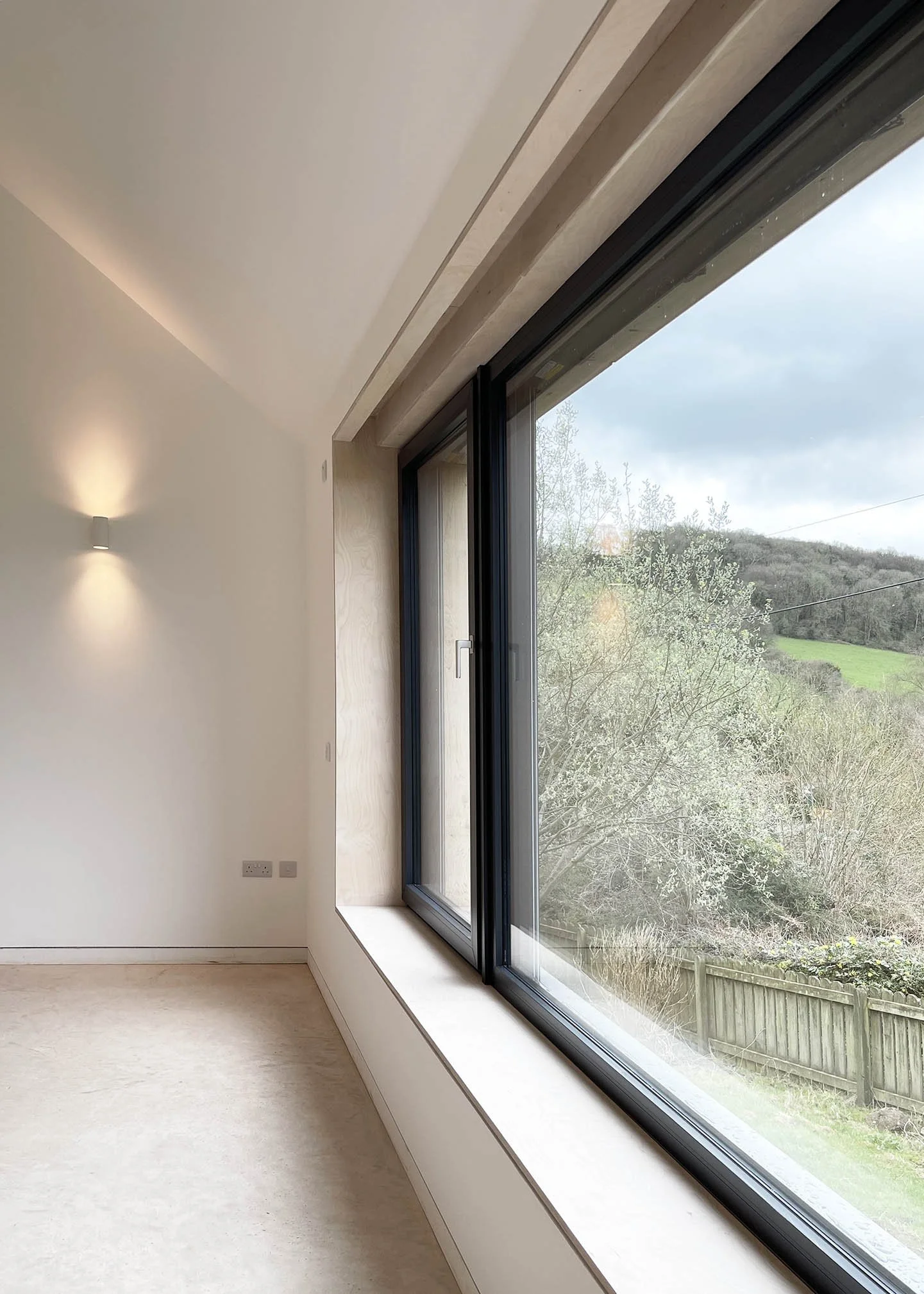 Bedroom wing within one of the gabled forms, providing private, calm spaces oriented towards the surrounding landscape.