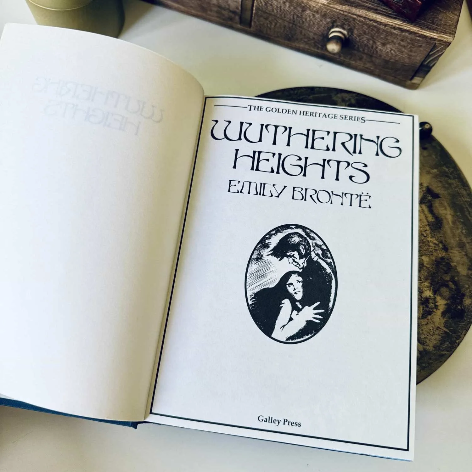 An open book featuring a title page for Wuthering Heights by Emily Bronte.