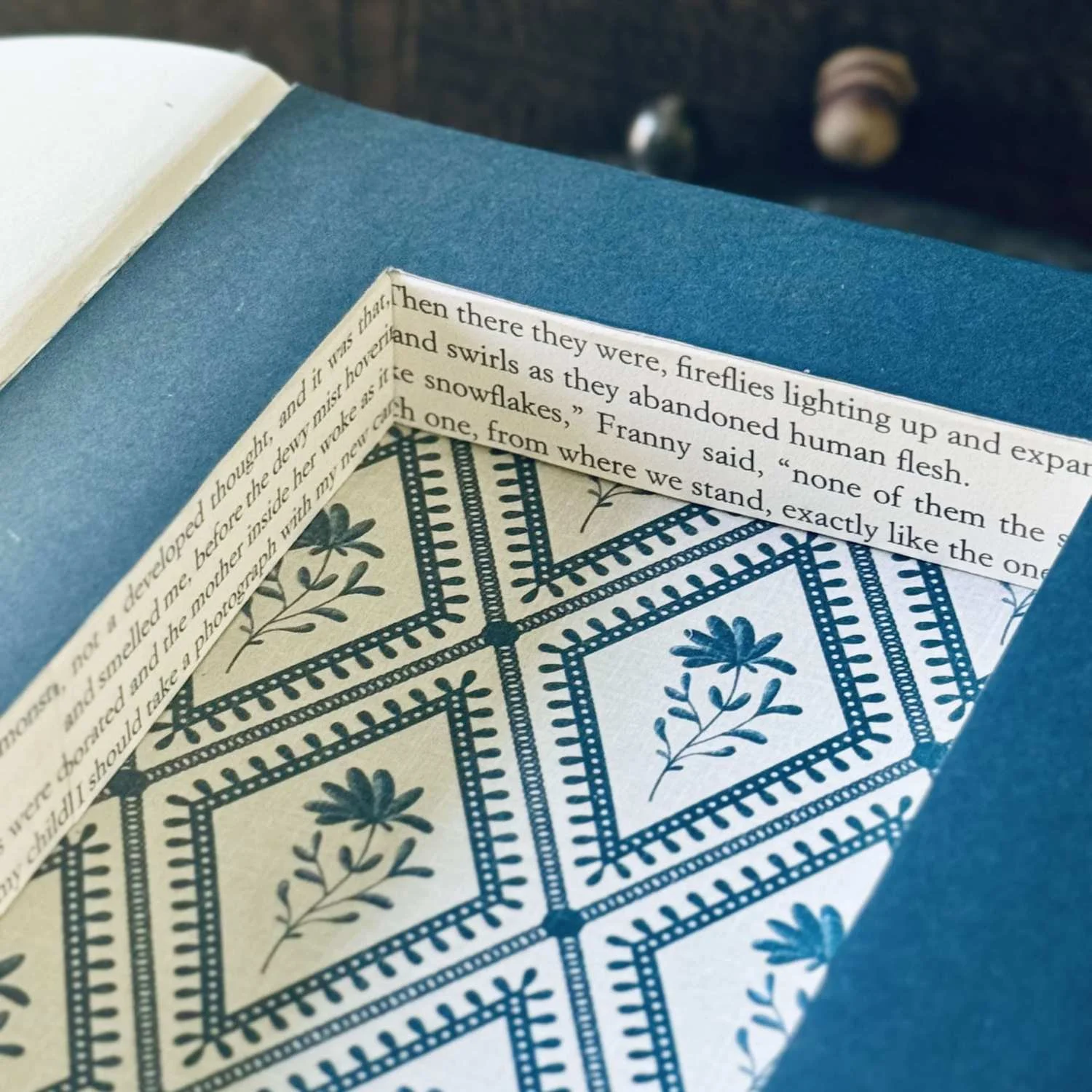 A close-up view of a hollowed out book decorated with navy blue floral paper (Copy)