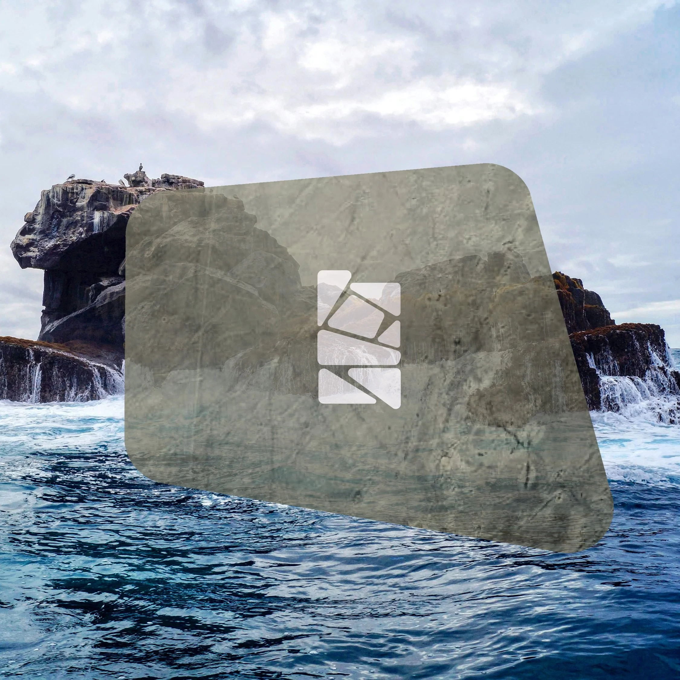 Ocean waves crashing against rocky cliffs under cloudy sky, in the Galapagos Islands, Ecuador,