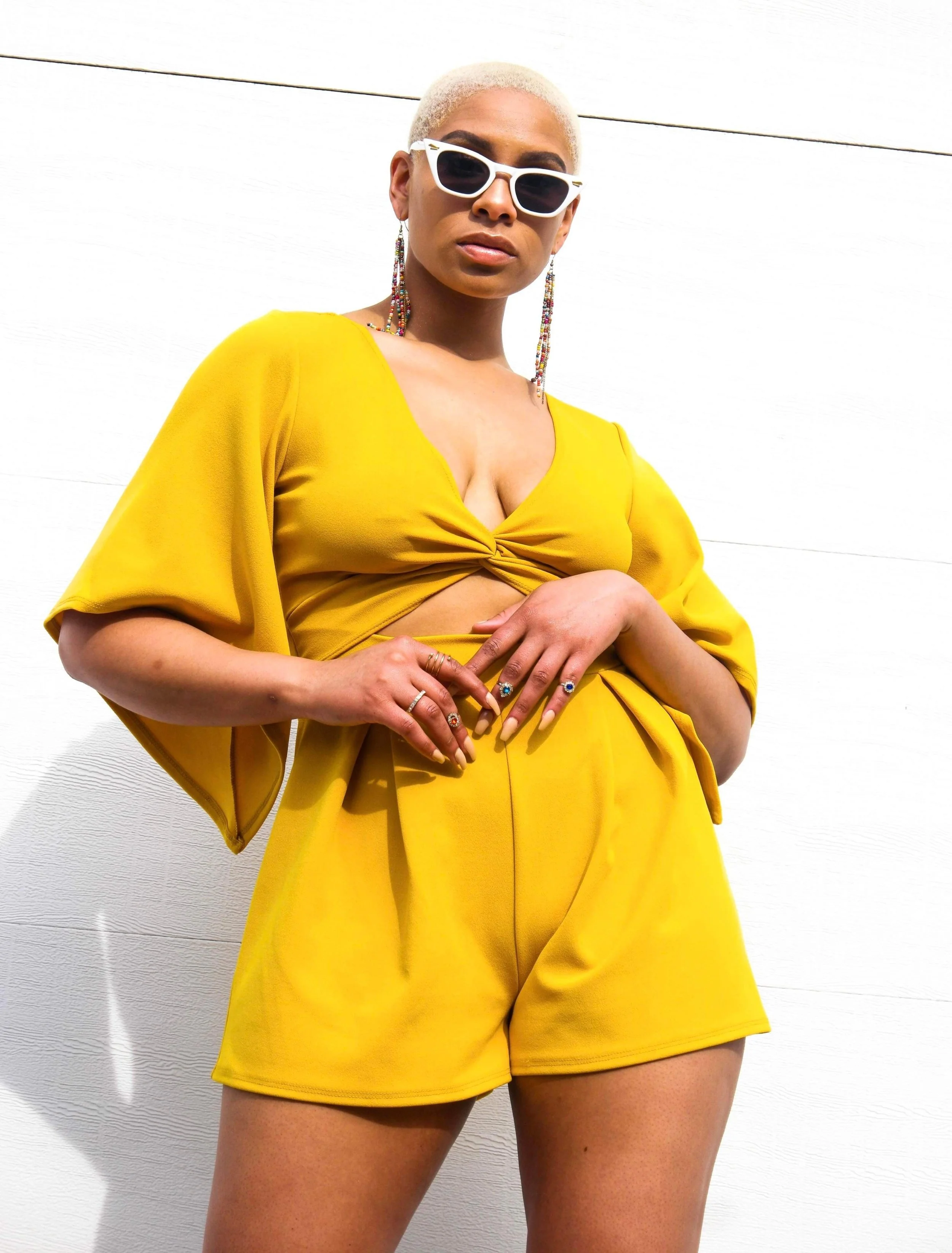 Fashionable person in yellow outfit with sunglasses