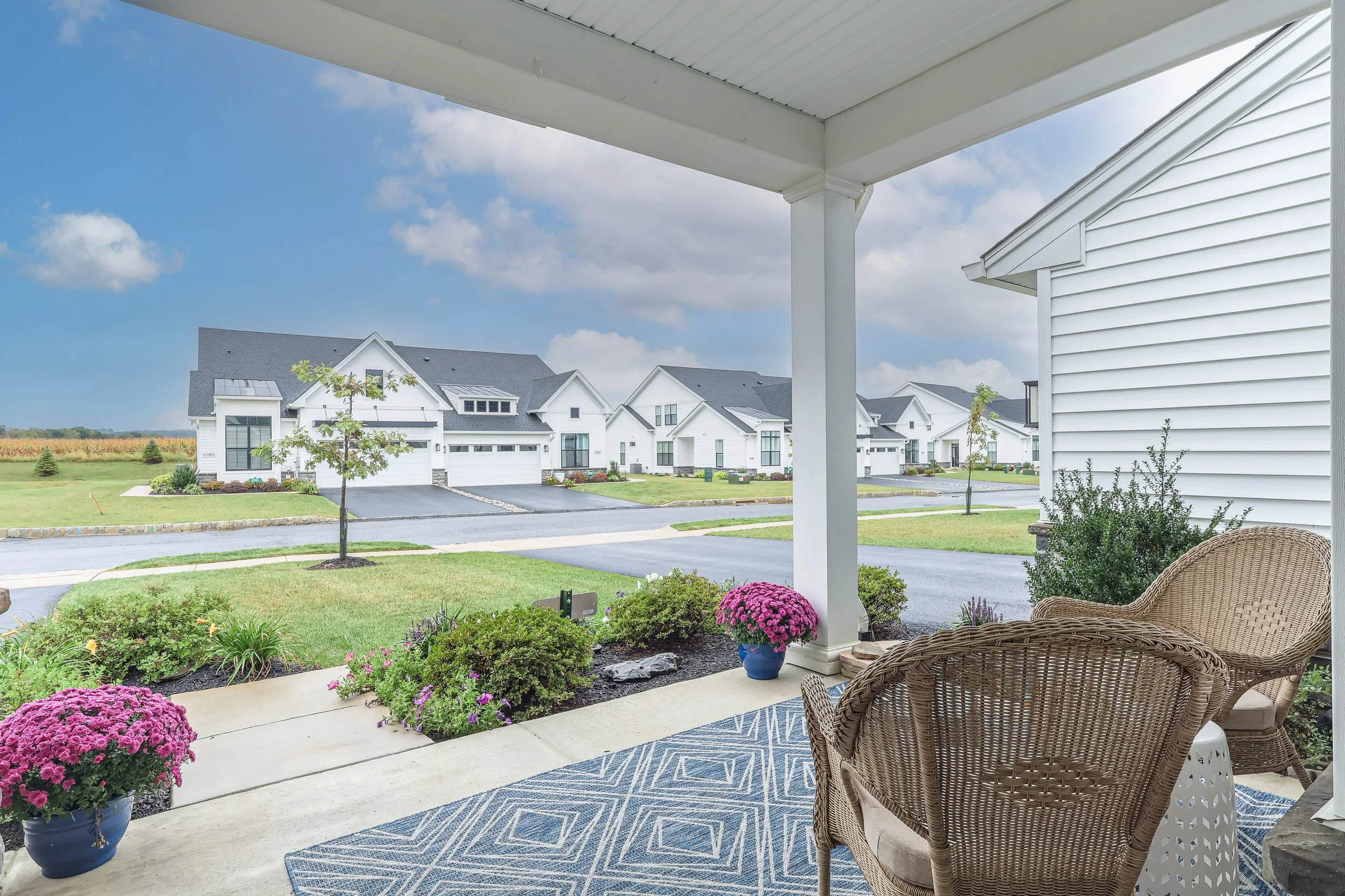 A welcoming front porch with wicker chairs, perfect for relaxing outdoors.