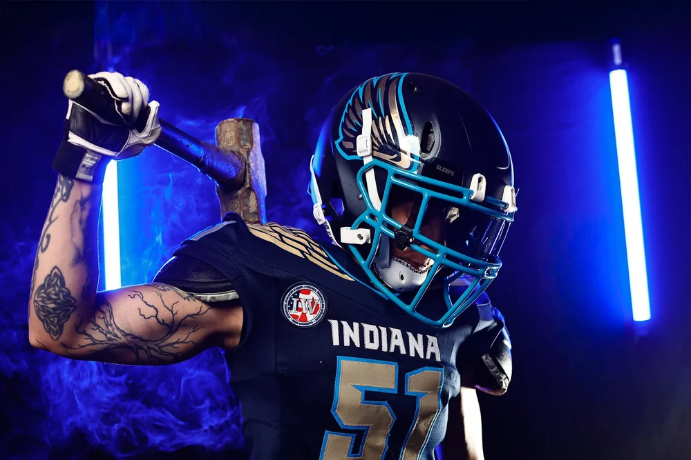 Athlete branding portrait of an Indiana Valor football player in a helmet and number 57 jersey holding a sledgehammer, Indianapolis
