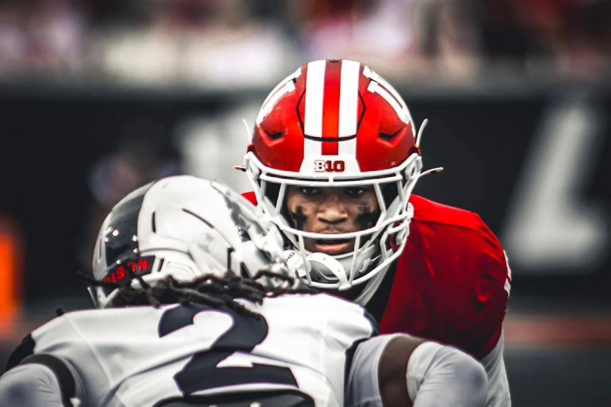 Close-up of an Indiana player in a crimson helmet facing an opponent at the line.