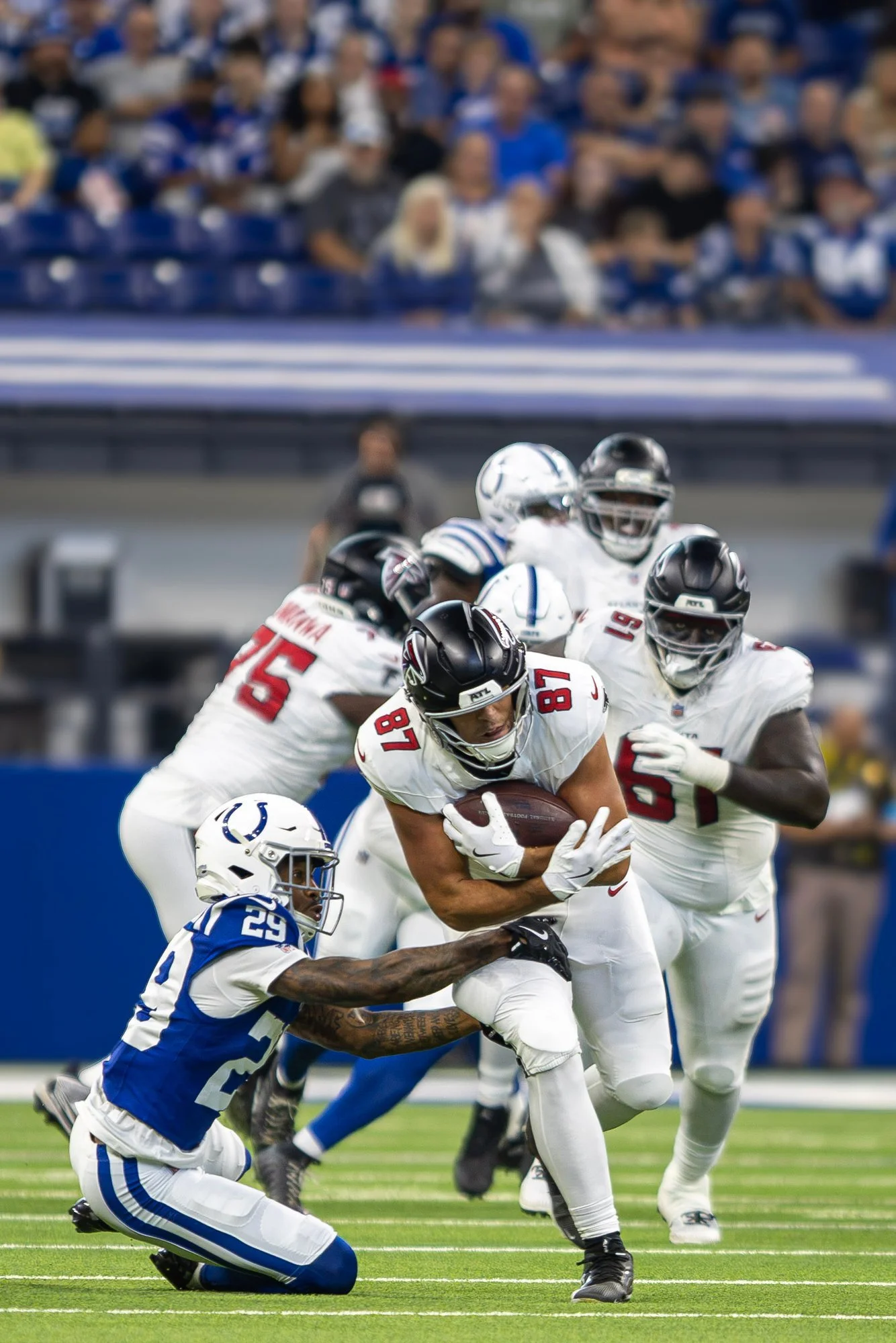 Several Falcons defenders converge to bring down a Colts ball carrier.