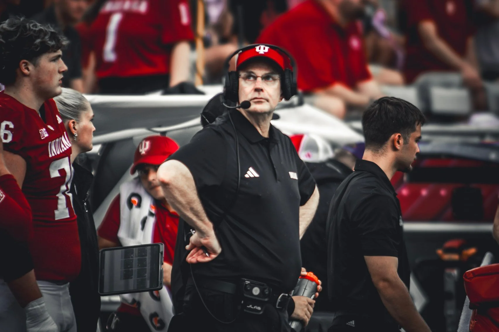 Indiana coach wearing a headset watching the action from the sideline.