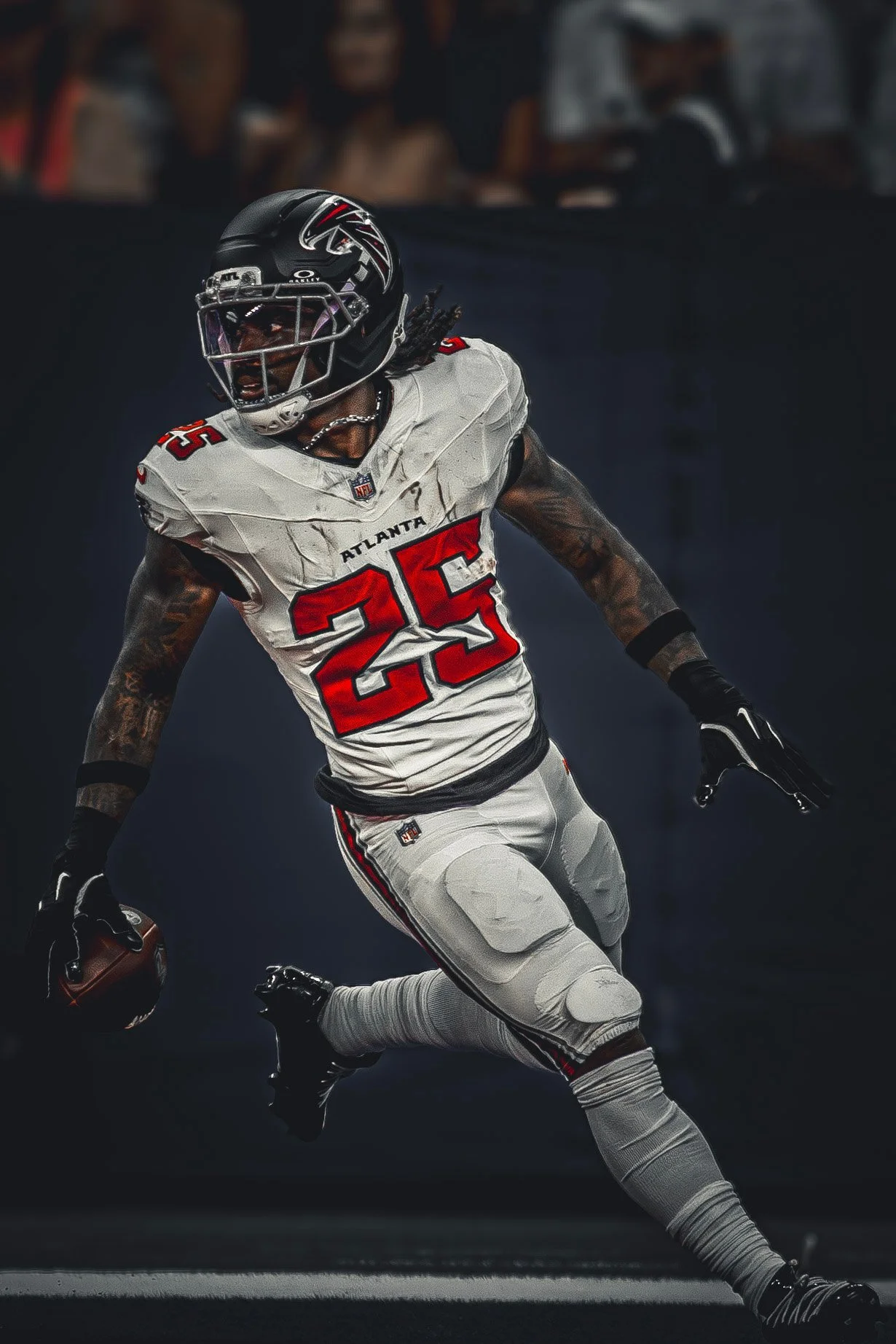 Falcons ball carrier in white running with the football against a dark background.