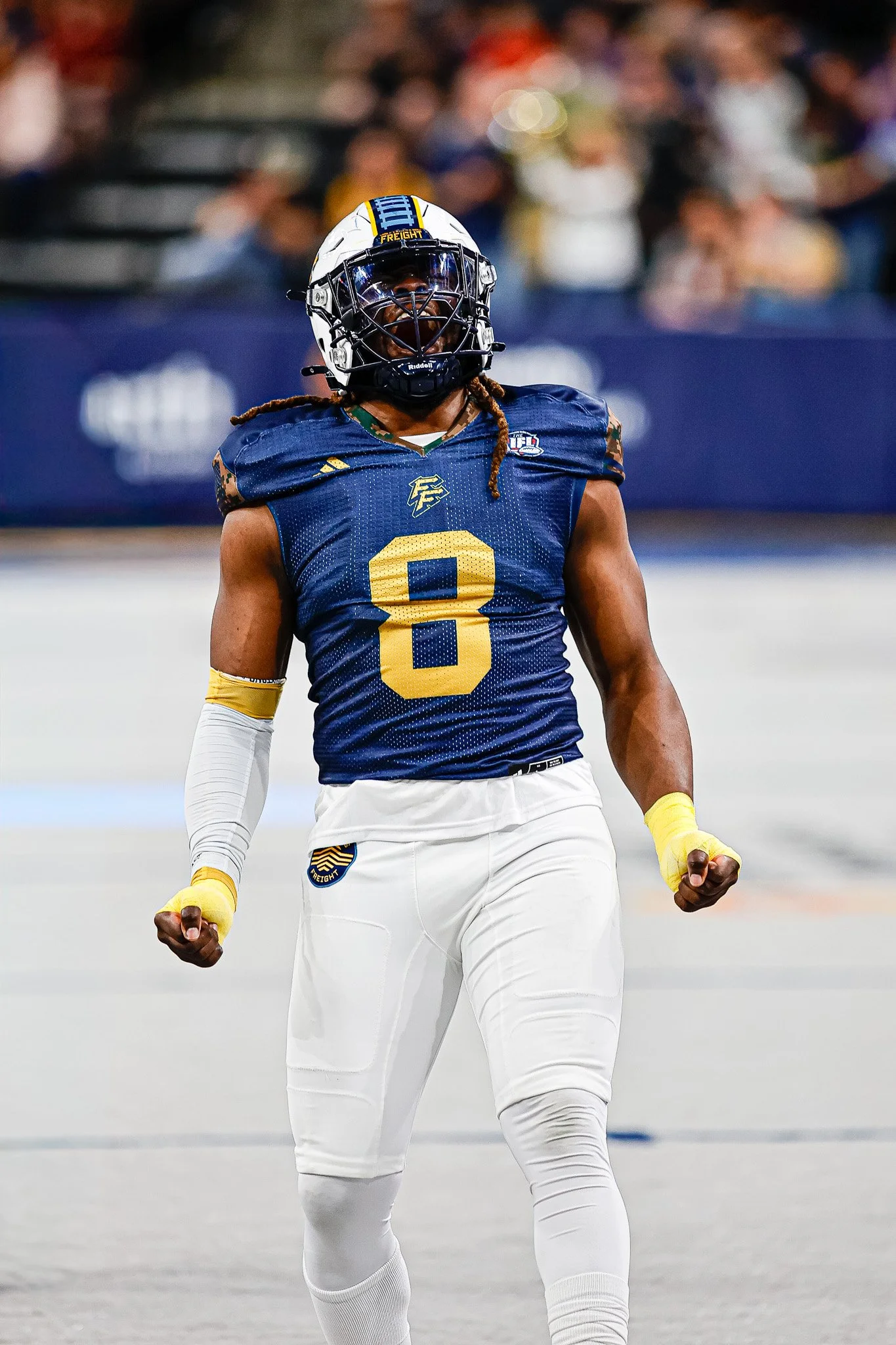 Indoor football player #8 celebrating on the field