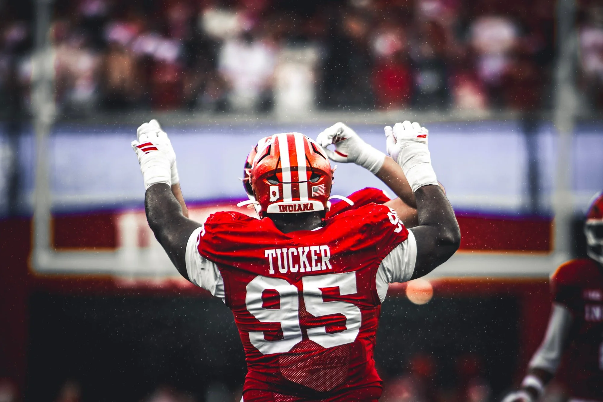 Indiana defensive lineman flexing both arms in celebration.