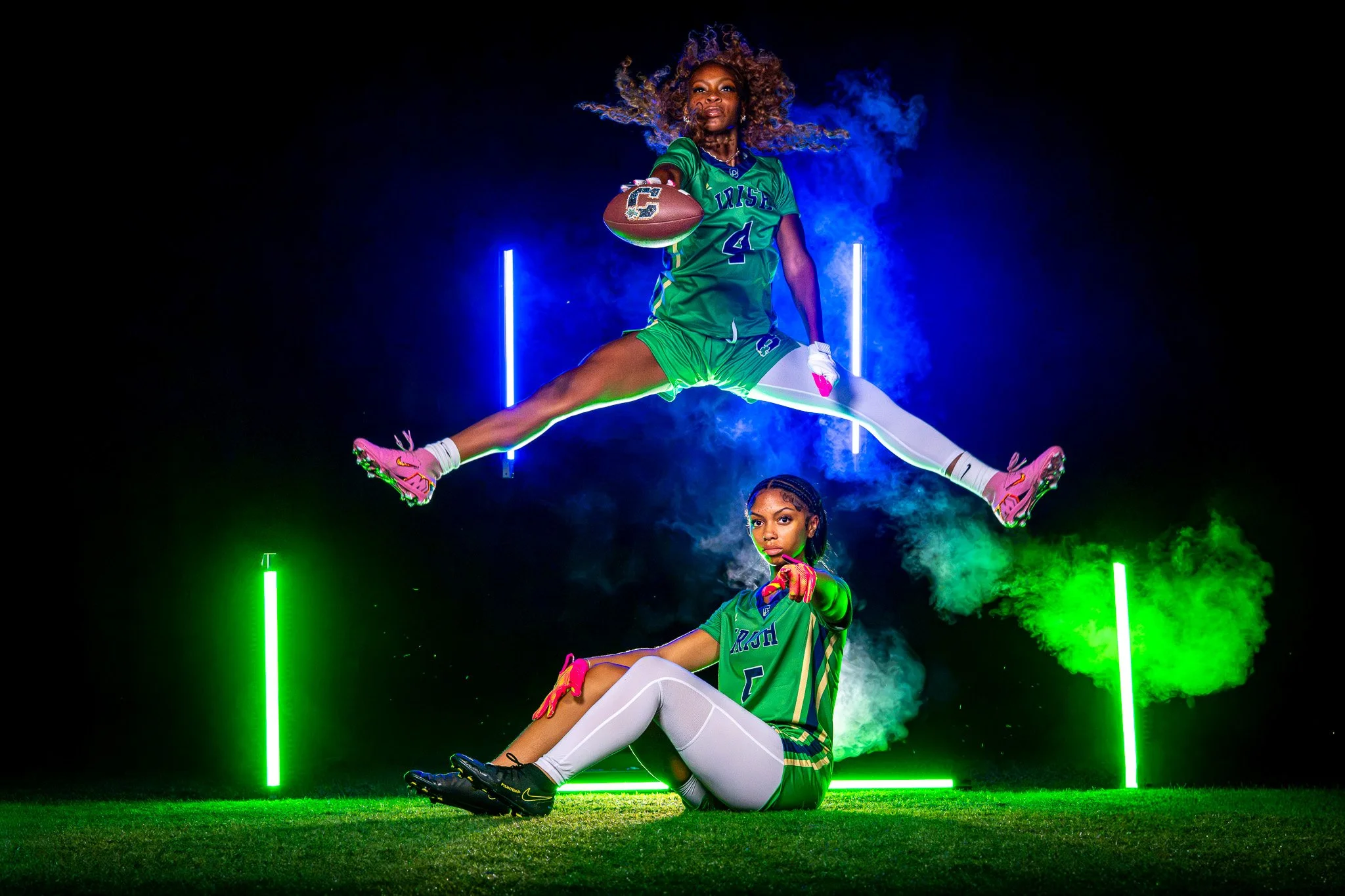 Girls flag football players in neon light and smoke portrait