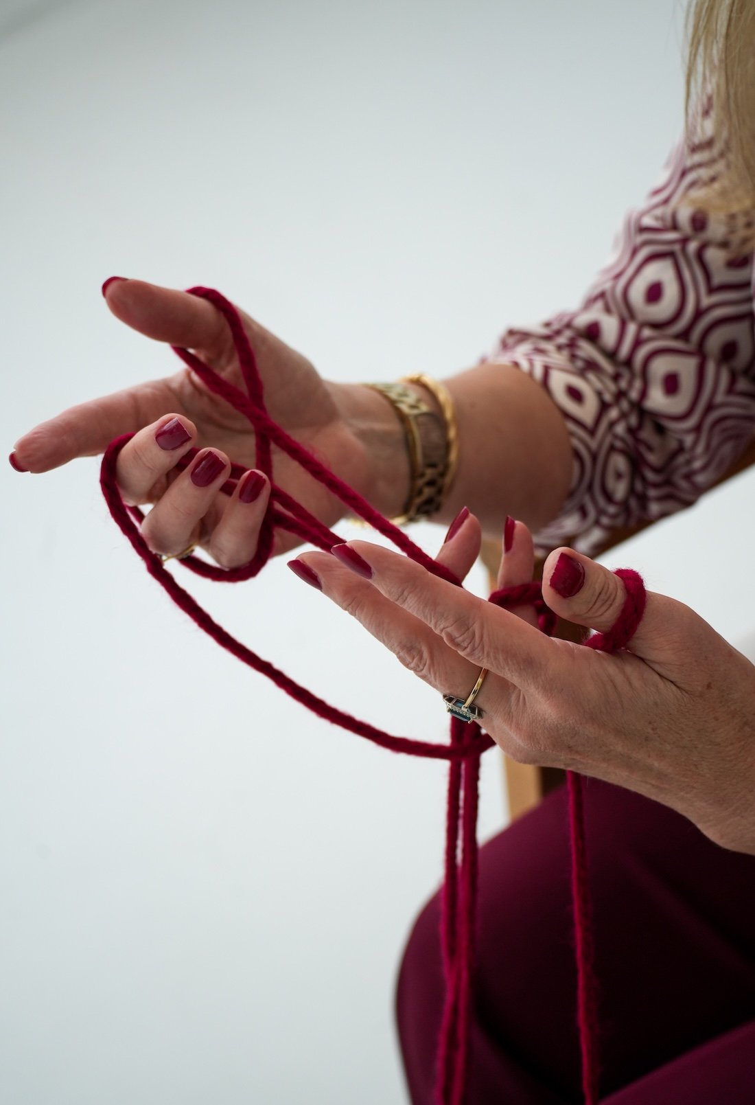 Symbolic hands with red thread imagery representing connection and healing through therapy at Red Thread Relationships, NSW-based counselling service.