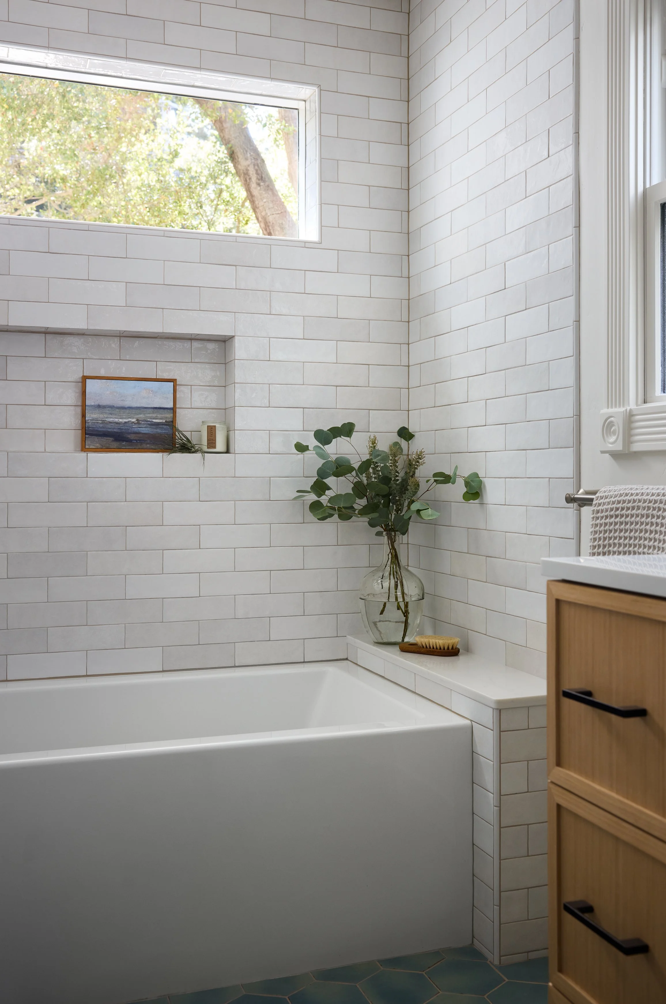 Bathtub with shelf and niche in a primary bathroom designed by Kelsey Brown Interiors in Aptos, California. 