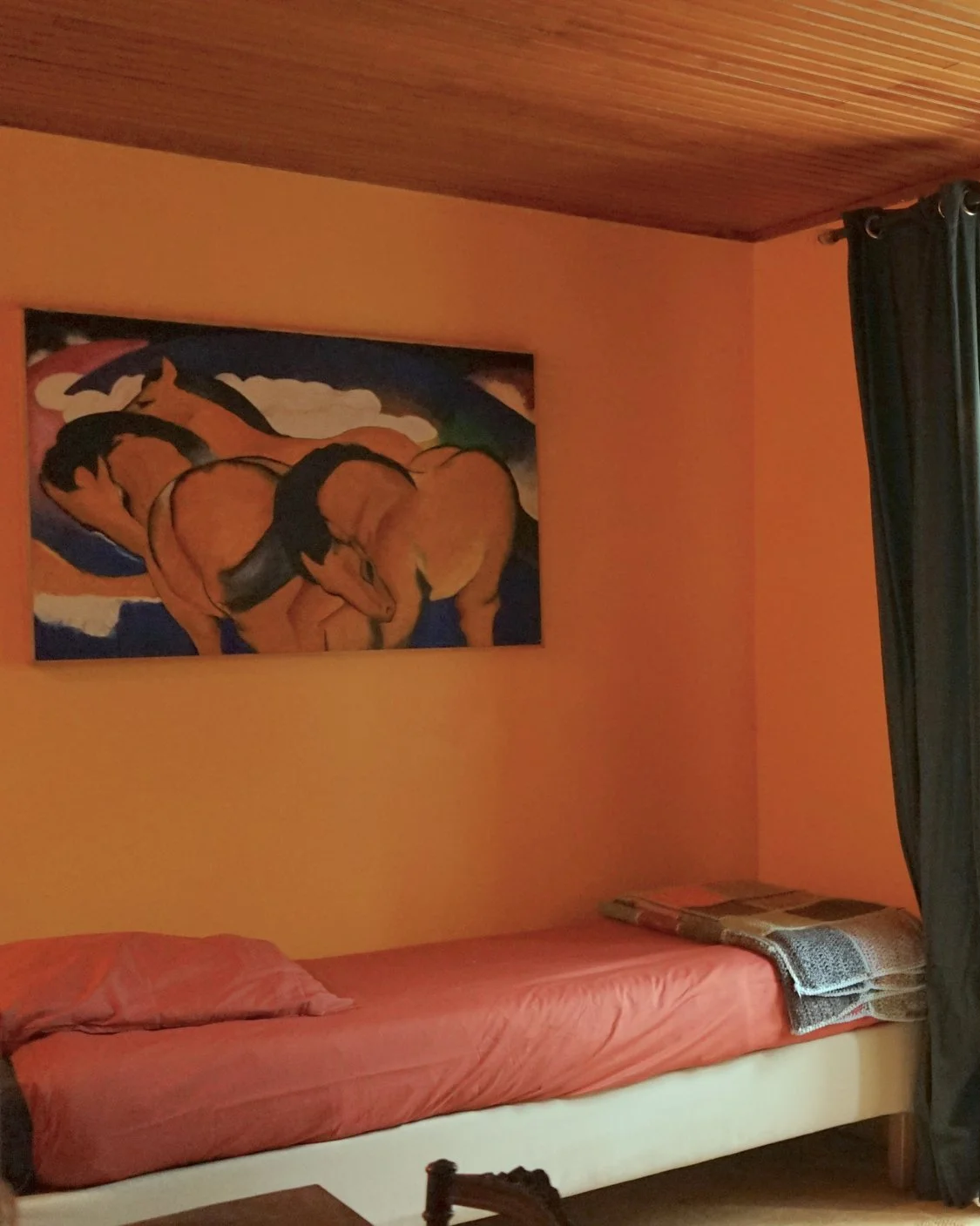 A cozy bedroom with a single bed in a rustic room