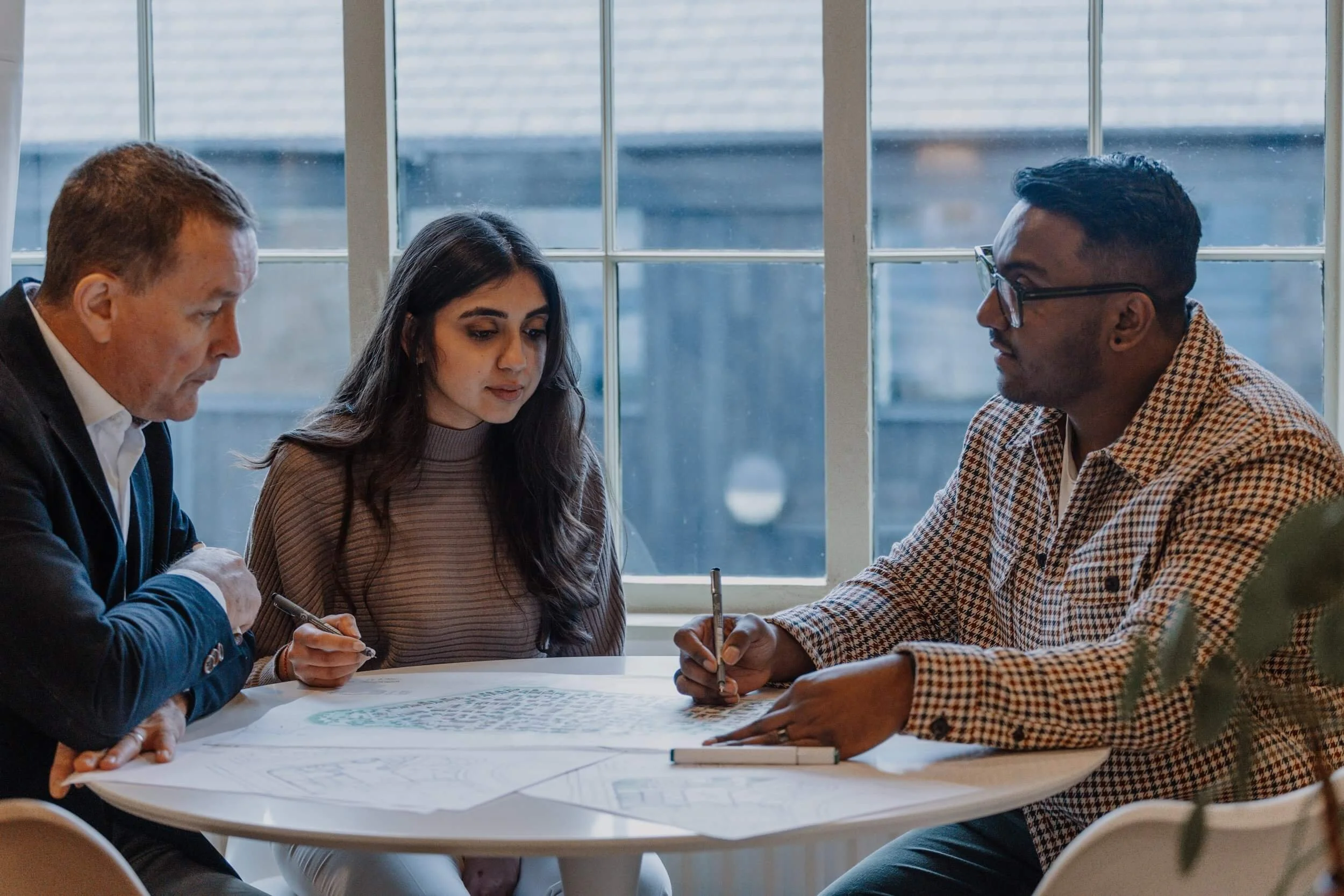 managing director shelly reviewing architectural plans at the 24/Three studio