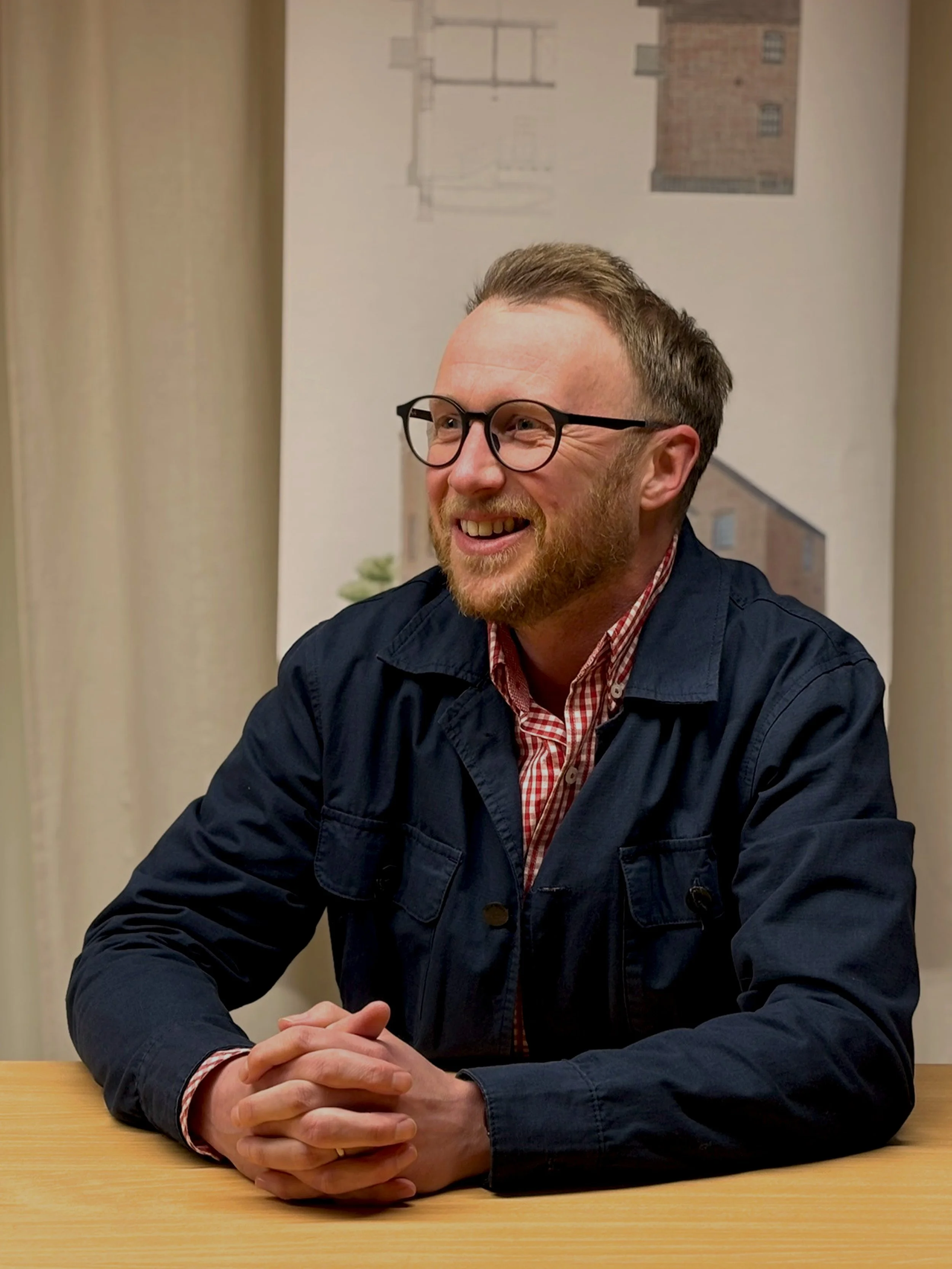 James, our associate director sitting in front of desk