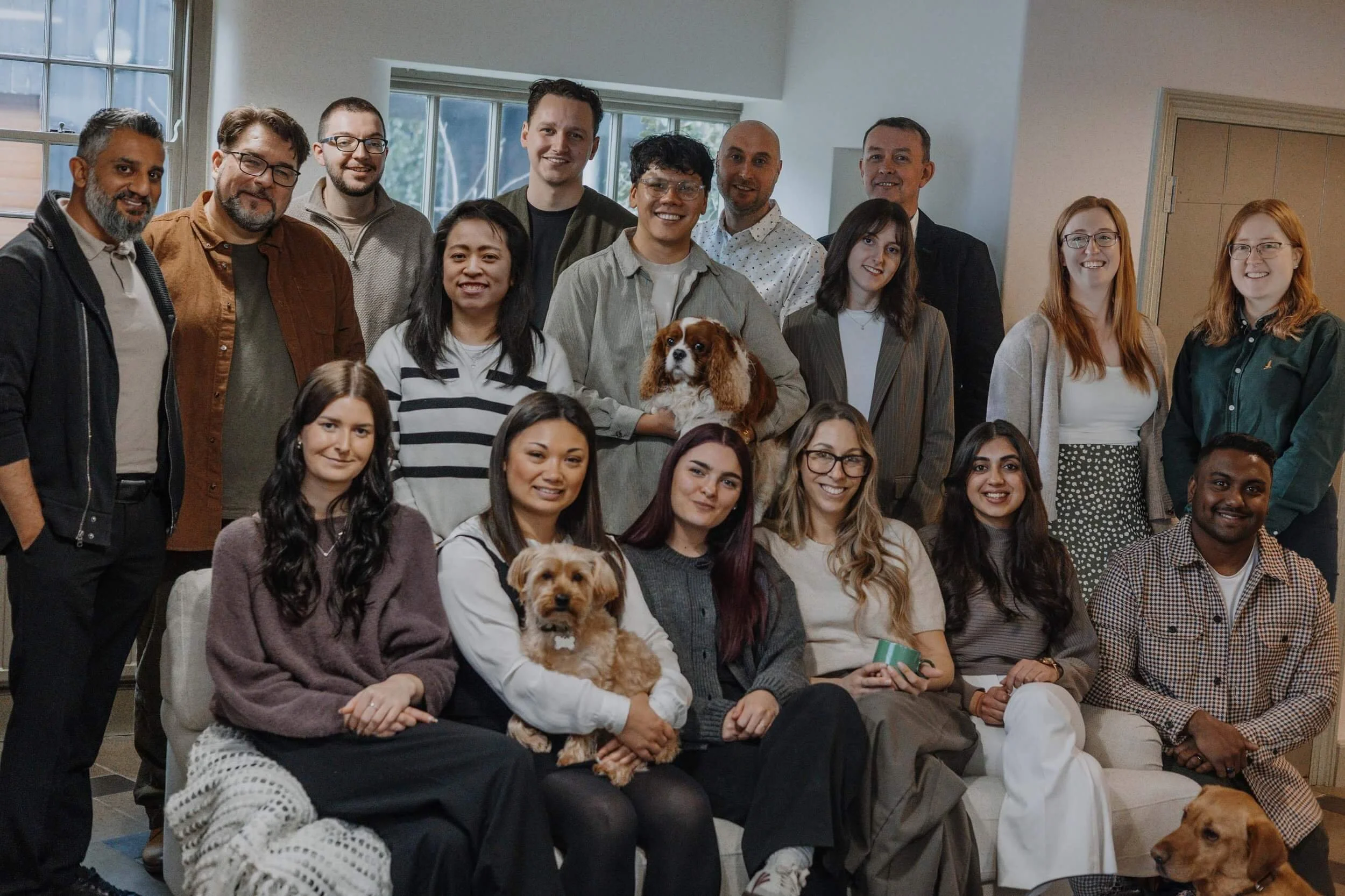 Group photo of the 24/Three architectural team with their dogs in the Nottinghamshire studio