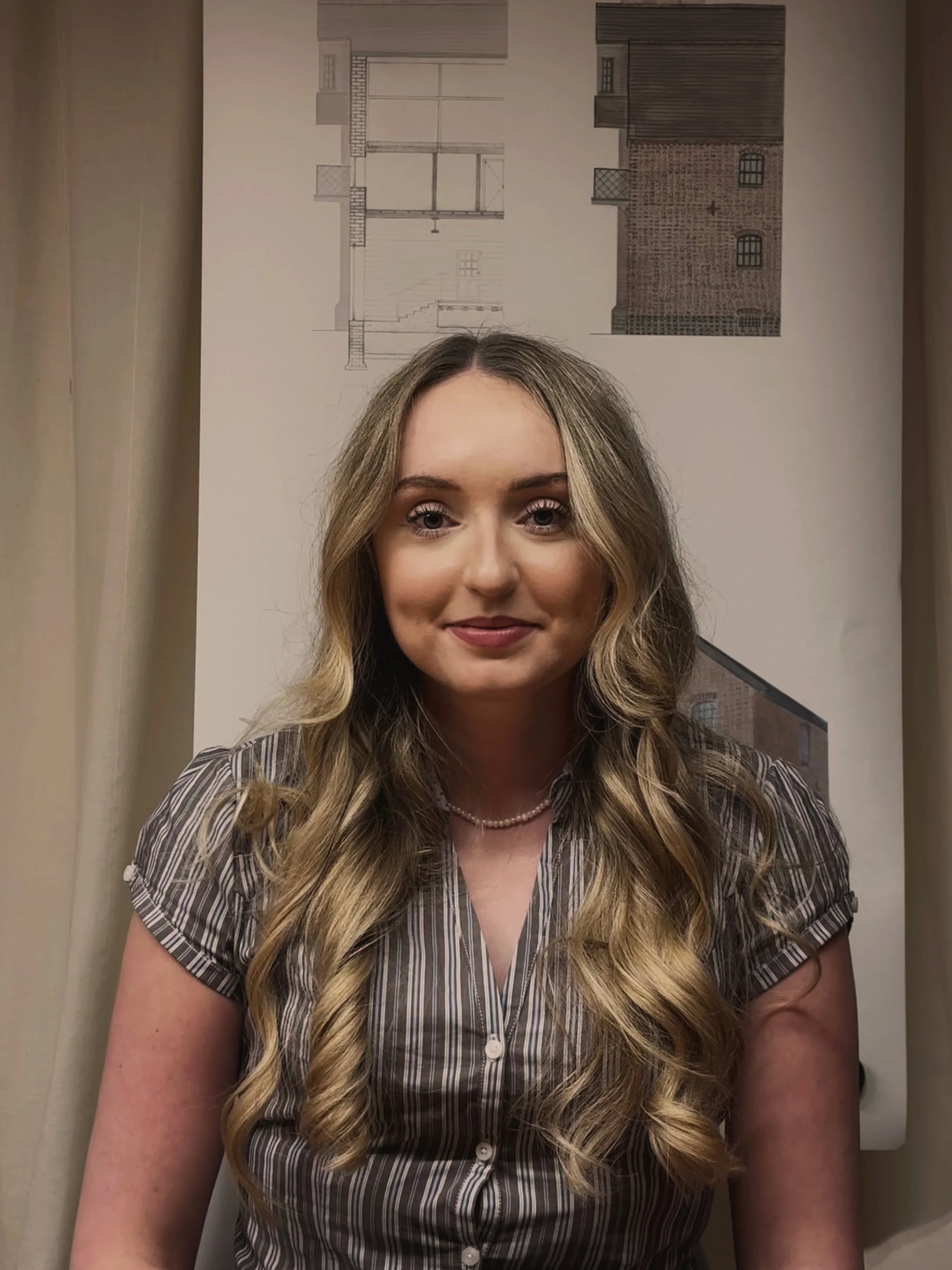 24/Three Charlotte wearing a stripy blouse in front of a watercolour background